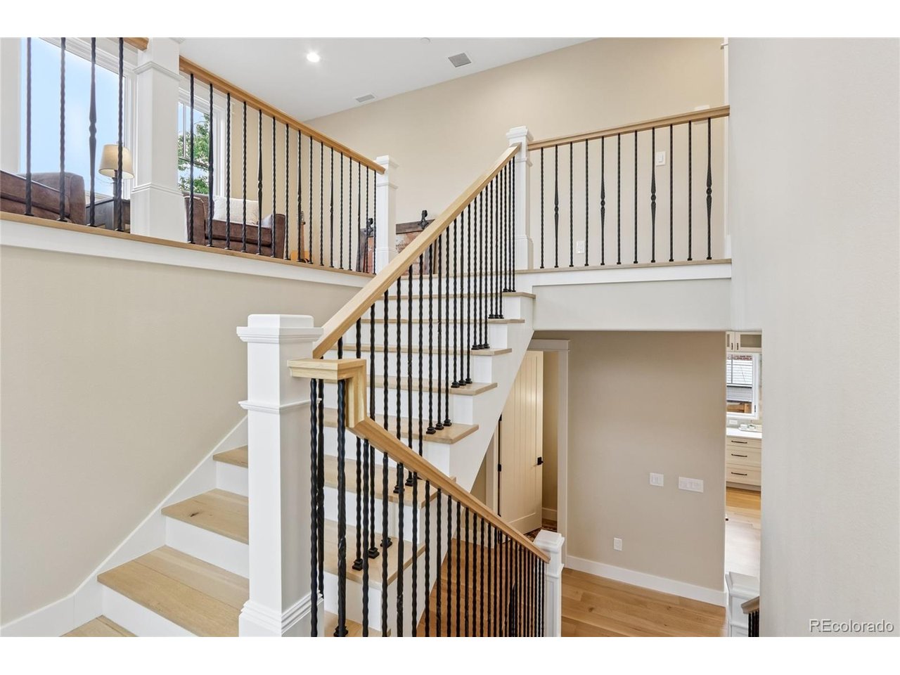 Experience the pinnacle of high-end, low-maintenance living in this stunning, recently built residence in Louisville's coveted Fischer's community. Boasting striking curb appeal, the home welcomes you with a charming covered front porch perfect for morning coffee. Inside, a breathtaking great room seamlessly unites the living, dining, and kitchen areas. The living room features a gas fireplace, dramatic vaulted ceilings with beams, and custom built-ins. Doors from the living and dining areas open to the backyard patio for unparalleled indoor-outdoor flow. The gourmet kitchen is a true showstopper, equipped with quartz countertops, a chic tile backsplash, a massive walk-in pantry, and an oversized island with a breakfast bar and a striking copper sink. The main level also hosts a convenient half-bath and a private guest suite with its own en-suite bathroom. The upper level is anchored by a sun-filled loft space. The primary suite serves as a true sanctuary, complete with soaring vaulted ceilings and a spa-like five-piece en-suite bath featuring dual sinks, a large walk-in shower, and a deep soaking tub. A dedicated laundry room with a utility sink completes this floor. For more entertainment space, the finished basement features a massive media room with a custom wet bar, an additional bedroom, a 3/4 bath, and a dedicated workshop. The backyard is an entertainer's dream designed for maximum enjoyment and minimum effort, featuring pristine low-maintenance landscaping, artificial turf, a massive patio, and a custom outdoor fireplace perfect for Colorado evenings. The detached two-car garage is accessed through the private backyard. Just two houses away, a neighborhood trail provides direct access to Cottonwood Park, all while being a short half-mile stroll from the vibrant shopping, dining, and cultural scene of Downtown Louisville. Blending contemporary luxury with a premier walk-to-town location, this masterpiece is a rare find.