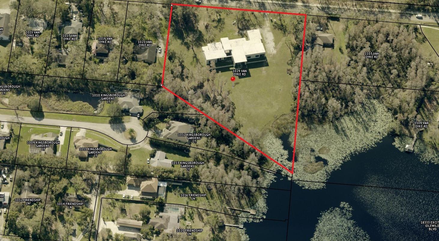WATERFRONT!!!  Available for sale is an oversized, half completed house on a 4.71-acre land site offering exceptional potential for multi-use development. The property is zoned RSC-2 (Residential Single Family Conventional, 2 units p/ acre) and features over 386 feet of frontage along Van Dyke Road, providing excellent visibility and access. The highest and best uses include a religious facility, adult education or trade school, assisted living or similar facility, private events center, rehabilitation or recreational facility, or an estate home, among other possibilities. The site includes a partially constructed single-family residence to be delivered as a grey shell, presenting limitless opportunities for residential or select commercial development. Plans, permits, budget, and a builder team are already in place to complete the project as shown in the renderings, with completion scheduled for 2026. The proposed structure encompasses approximately 9,000 square feet with 13 rooms, including 5 bedrooms, 5.1 bathrooms, and a 3-car garage. Additional features include two fireplaces, a wine room, inground pool and spa, gym, game room, double reinforced concrete roof, and lake frontage on Reinheimer Lake. The site is also suitable for community residential homes (Type A), conventional single-family dwellings, family daycare homes, libraries, public schools (K–12), public parks and recreation facilities, private passive recreational use, ambulance services, beekeeping, and more. Ideally located just off the signalized intersection of North Dale Mabry Highway and Van Dyke Road, the property sits within a rapidly growing residential district and represents a strong investment opportunity for future construction and development. It is minutes from the Suncoast Parkway, North Dale Mabry Highway, US 41, and the many amenities of northern Hillsborough County, with a 2024 population of 3,758 within one mile, 48,021 within three miles, and 167,661 within five miles. The asking price is for the land and the half built property "as is".