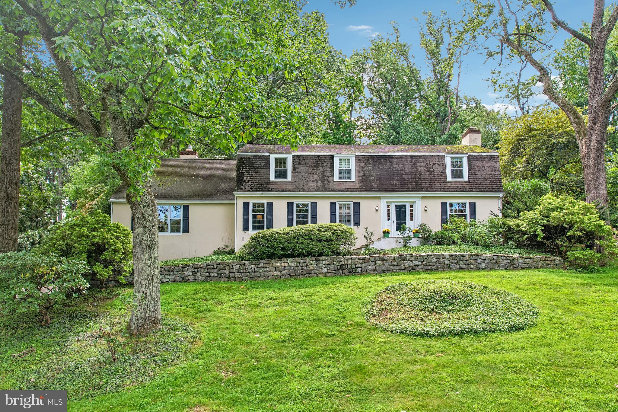DEADLINE FOR OFFERS IS 9/12 at 5pm.OPEN HOUSE FOR SUNDAY 9/13 IS CANCELLED.  Perched above the street in Devon’s sought-after Shand Tract, 472 Timber Ln offers approximately 3,372 square feet of living space surrounded by mature trees and a beautifully tiered setting. The welcoming foyer opens to a front-to-back living room featuring hardwood floors, a wood fireplace, abundant windows, and double doors leading directly to the patio and pool. Along the rear of the home, the dining room enjoys a bay window with views of the pool and connects to the generously sized kitchen with lots of counter space and an eat-in area. A convenient back staircase provides easy access from the kitchen to the second floor. The adjacent family room offers a gas fireplace and a comfortable gathering space. A first-floor den/office provides flexible additional space and is located near a full bath. Upstairs, five bedrooms include a spacious primary suite with a renovated bath, while two additional full baths with tub/shower combinations serve the remaining bedrooms. The unfinished lower level includes a mudroom and laundry area just inside the two-car garage, along with abundant storage, a workshop, and a large open area offering future finishing potential. Outside, the backyard creates a private retreat with an in-ground pool and waterfall, patio, tiered landscaping, a level area for recreation, and a storage shed. With its elevated position, wooded outlook, generous room count, and distinctive pool setting, this Shand Tract home offers a unique opportunity in Devon. Showings start 9/10/26.