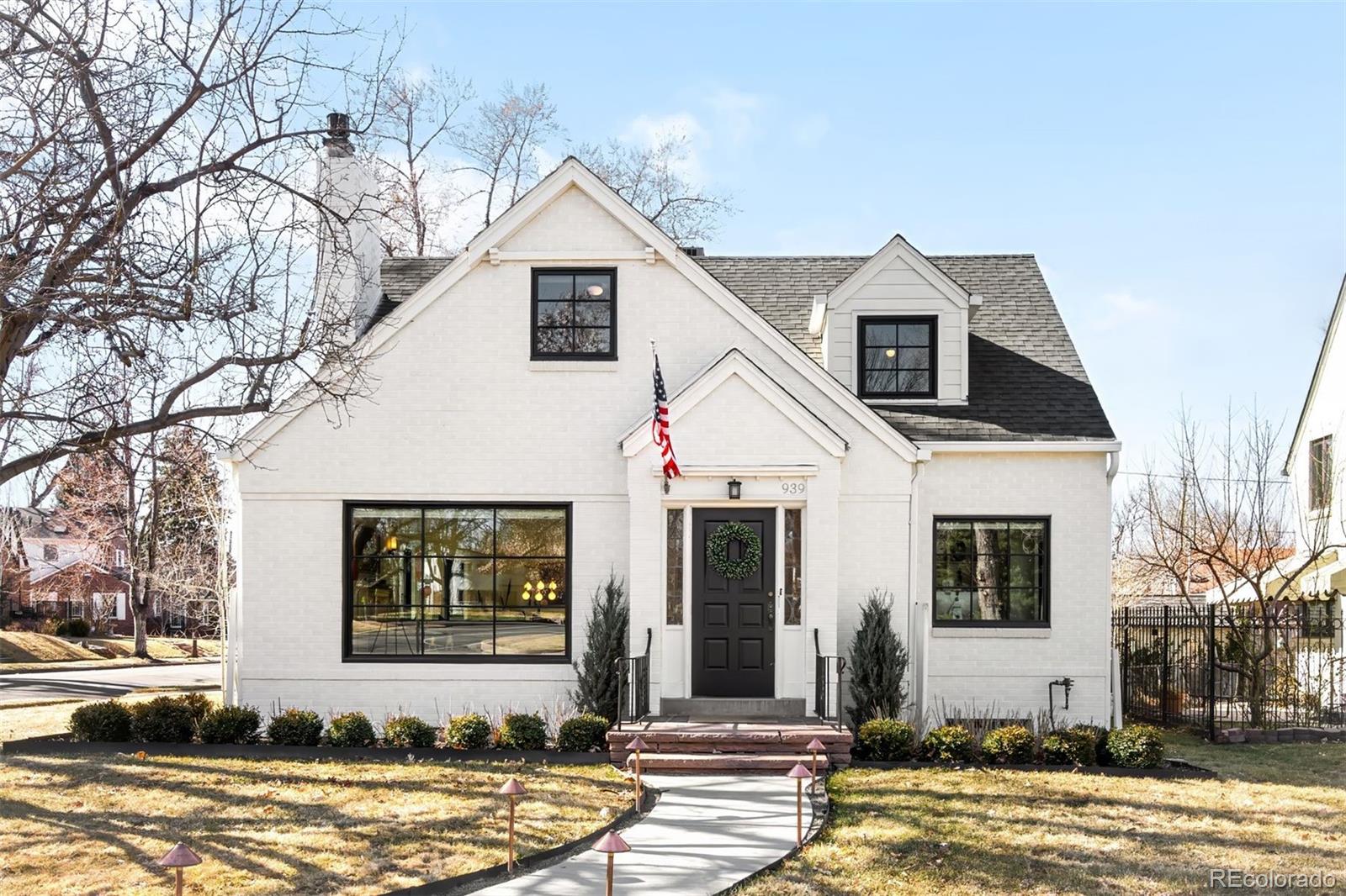 Curved, tree-lined streets radiate from one of Denver’s best-kept park secrets — Bonnie Brae Park — a charming oval green designed in 1920 to evoke a Scottish village. Directly across from the park, this west-facing 1941 Tudor captures sweeping green views through a custom 60” Marvin window, filling the home with warm afternoon light. With only three owners in its history, this residence blends timeless architecture with an exceptional location.Hardwood floors lead into a sunlit living room anchored by a striking stone Art Deco fireplace. Arched doorways and crown molding add architectural character, while expansive windows frame the park like a living backdrop. The dining room offers an inviting space for gatherings, and the well-appointed galley kitchen features a Dacor gas range, stainless appliances, custom cabinetry, and a built-in desk area for everyday functionality.A vaulted family room opens seamlessly to a private patio surrounded by mature trees, creating an ideal indoor-outdoor connection. A main-floor bedroom or study with a finished bath adds flexibility for guests or work-from-home needs.Upstairs, the primary suite provides a quiet retreat, accompanied by two additional bedrooms and a full bath. The finished lower level includes a cozy fireside lounge, generous laundry space, abundant storage, and a versatile non-conforming room.Enjoy a lifestyle that is both connected and walkable — just five minutes to Gaylord Street, Bonnie Brae Ice Cream, and the neighborhood library; ten minutes to Wash Park; fifteen minutes to Cherry Creek Shopping Center; and a short drive to the Denver Botanic Gardens. A private walking trail and beloved neighborhood traditions — wine club evenings, alley art walks, and summer parties in the park — make this location truly special.