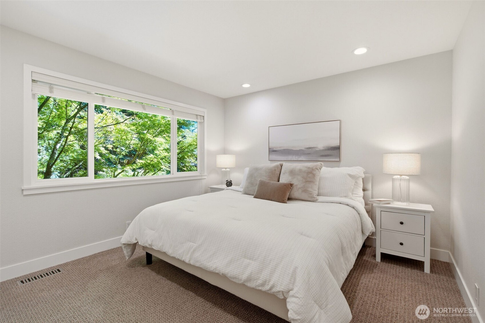 Bright bedroom overlooking tranquil greenery.