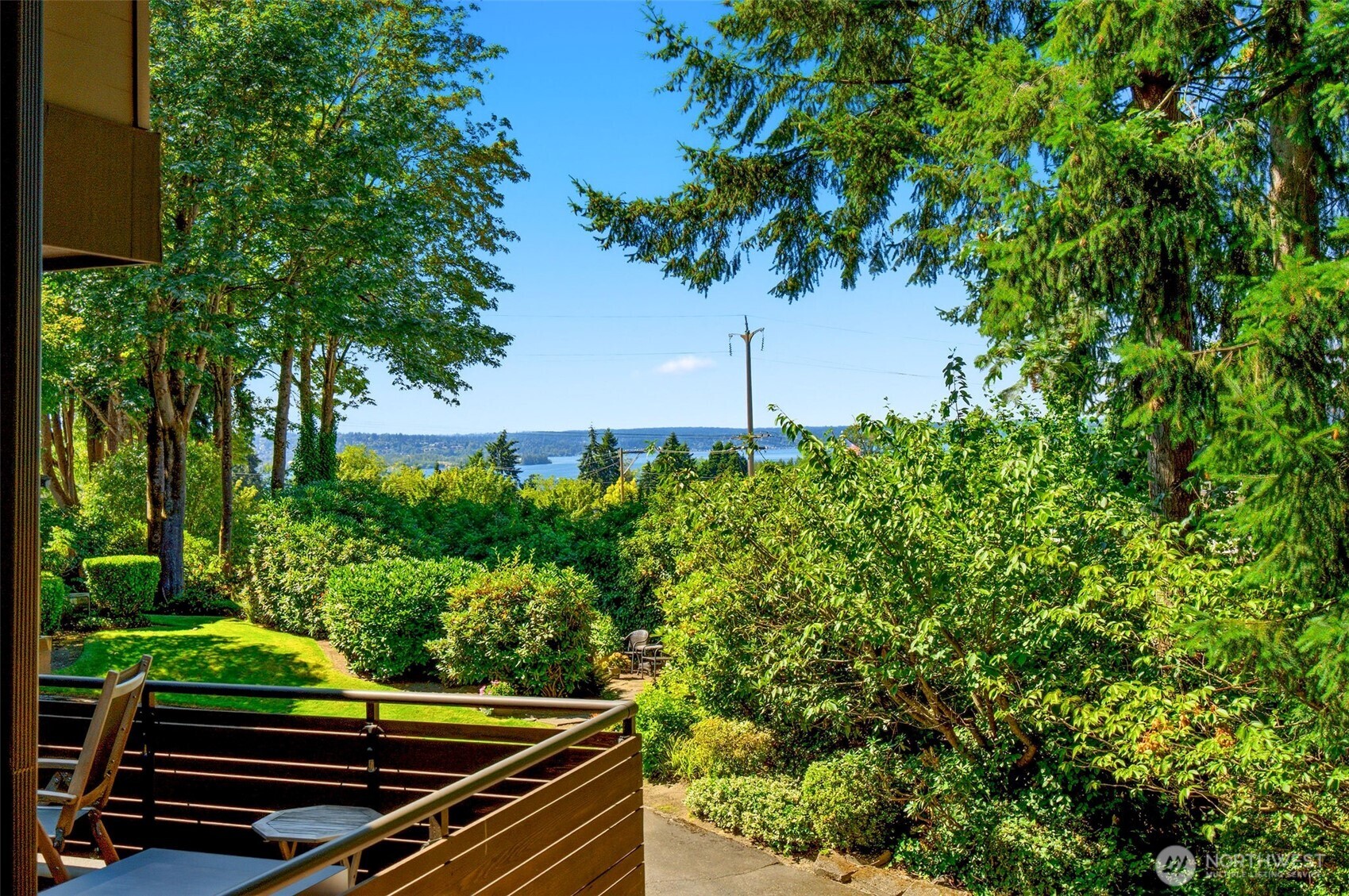 Peaceful outlook framed by lush greenery with glimpses of the surrounding landscape.