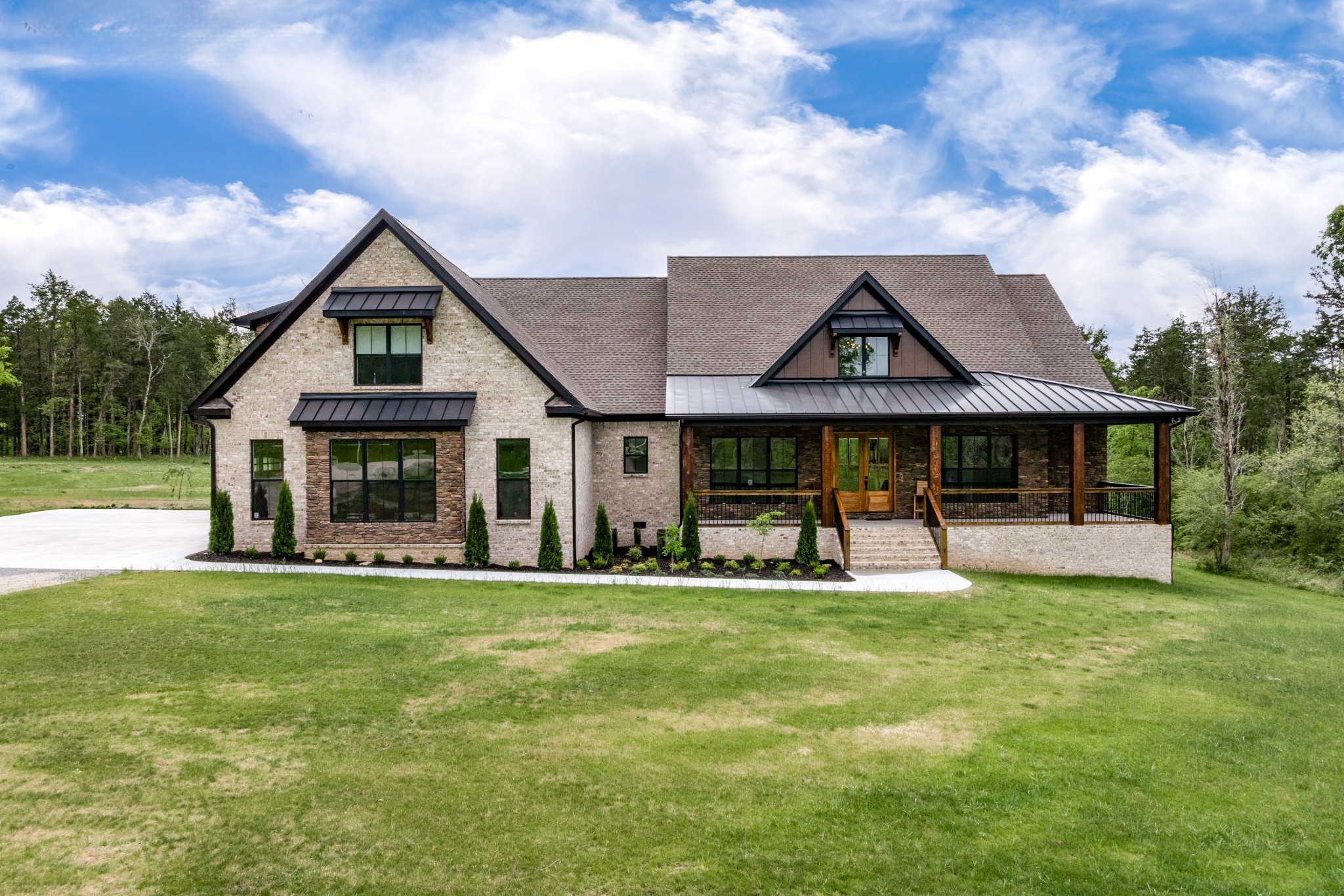 This home will check boxes you didn't know you had!! Upgrades and specialties galore. Brick and stone modern luxury home on 10.65 Flat acres. Once inside one will be filled with feelings of grandeur. Take in 20ft tall ceilings, wooden beams, floor to ceiling stone fireplace and rustic wooden look of the LVP flooring. Modern meets rustic meets farmhouse in a beautiful symphony of kitchen, living, dining and even outdoor space. The kitchen offers True "Top of the Line" Frigidaire Professional series Appliances including a double fridge/freezer (66" wide), Dishwasher, Double Oven w/Convection plus Warming Drawer. The 37" Custom Hood compliments a Bosch cooktop. Carefully selected Carrara Backsplash is perfect against the Cyber Space darker paint tones and striking veins of the Port Rush Quartz brings it all together. Large walk in pantry built into the beautiful modern custom cabinets This remarkable home offers 4 larger bedrooms,3 on the main floor, and 6 bathrooms (all bidets). Oversized master bedroom has His and Hers EVERYTHING- Including his/hers private bathrooms in the master en suite and massive his/hers custom closets, including a hidden “Safe” complete room w/a steel vault door, built to hurricane standards. Tile flooring, heated floors, quartz vanities, pocket doors, private bidets, shower heads and seating for 2 enhanced by fine tile w/pebble accent plus soaker tub. Upstairs you will find a spacious bonus room and bedroom (currently being used as a theatre/media room). Entertain away or retreat to the outdoors for ultimate experience. Senses awaken when you step into the enormous screened in back patio w/ every amenity you could want. The most impressive outdoor custom kitchen awaits offering Top of the Line Firemagic huge grill and griddle, huge Island with leathered granite, 2 towering hoods plus a mini fridge. Take a swim in the heated in ground pool or enjoy watching deer in your backyard while sitting in the hot tub taking in warmth of stone fireplace.