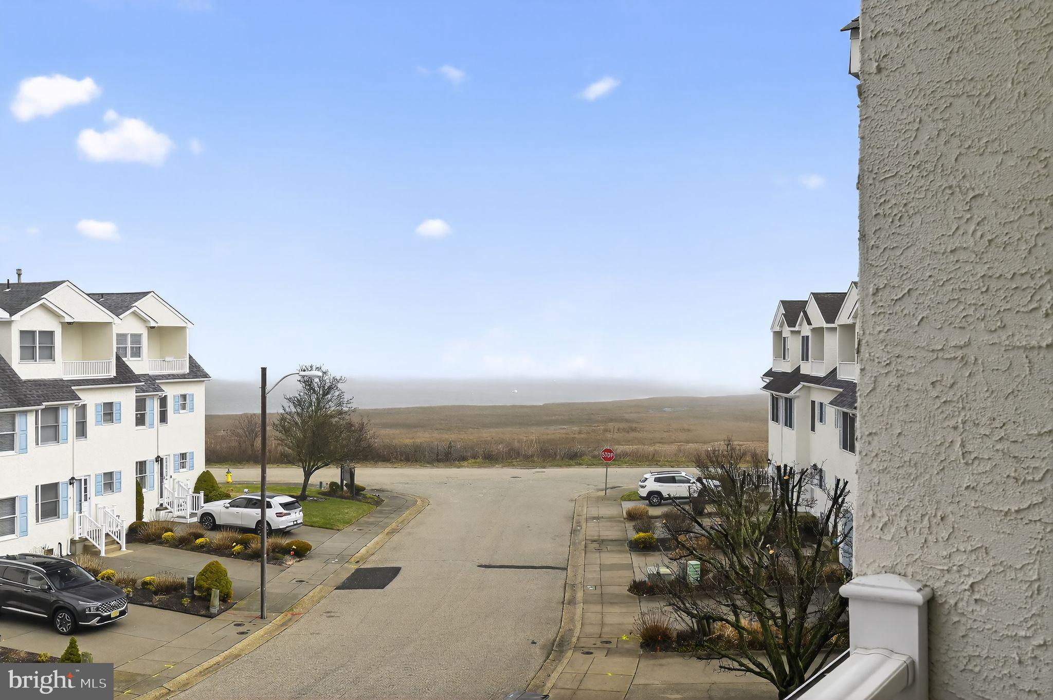 Welcome to coastal living at its finest in the highly sought-after King’s Cove community on the southern point of Brigantine Island! This beautifully updated three-story townhouse features stunning hardwood floors throughout along with 3 bedrooms, 2.5 baths, and an incredible blend of space, style, and seaside convenience and tons of natural sunlight.Step inside on the first floor, where you’ll find two generously sized bedrooms—one with direct access to a private rear deck—along with newer remodeled full bathroom featuring a walk-in shower. This level also includes a laundry room with washer and dryer, plus additional storage space for ultimate functionality.The second floor is designed for entertaining and everyday living, showcasing an oversized, updated kitchen with a large center island, granite countertops, and newer appliances. The open-concept layout flows seamlessly into a dedicated dining area and a warm, inviting living room. Step outside from the kitchen onto the second-floor balcony—perfect for enjoying morning coffee or evening breezes. A convenient half bath completes this level.Retreat to the third floor where the spacious primary ensuite awaits, featuring a walk-in closet and a luxurious remodeled  full bathroom with a walk-in shower and a beautiful standalone soaking tub. Enjoy your own private balcony right off the bedroom, plus an additional front-facing balcony at the dormer—offering even more outdoor space to relax and unwind.Additional highlights include a New roof  in 2024,  New HVAC system installed in 2021,  beautifully painted exterior in 2023,  Interior painted in 2026 ,  new remodeled bathrooms in 2021 and so much more. all while providing peace of mind and added value. The home also offers exterior storage for all your beach gear and multiple outdoor spaces to fully embrace shore living. Ideally located just minutes from Atlantic City and within walking distance to Seapoint beaches, shops, restaurants, and everything Brigantine has to offer—this is the perfect opportunity for a primary residence, vacation home, or investment property.Don’t miss your chance to own a piece of the island lifestyle!