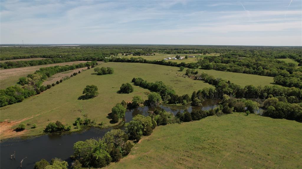 This 197 + acre ranch property is a dream for those seeking their own piece of Texas paradise! Adjacent to Corps of Engineers land and near Lake Texoma, the ranch offers rolling terrain with varied topography, spectacular panoramic views, plenty of mature trees scattered throughout, pastures for grazing cattle, wooded areas, and multiple tanks stocked with catfish and bass. The quaint 4-bed, 2-bath country home at the front of the property offers a spacious living area, an open eat-in kitchen w a separate dining area, 4 large bedrooms including one with an ensuite, and a covered front and back patio ideal for spending your evenings. Outside, you'll find two outbuildings totaling 3200 sqft and 2800 sqft of carport space, perfect for keeping all your necessary farming and ranch equipment. Only an hour to the DFW metroplex and minutes to shopping, grocery, entertainment, and Lake Texoma, this property truly is a gem!