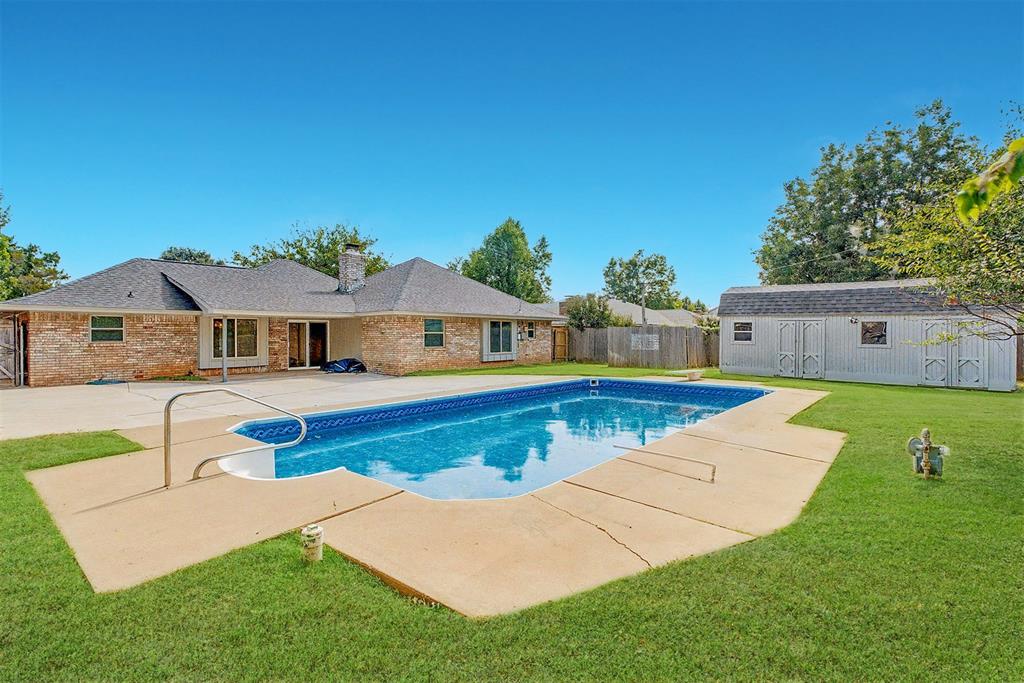 Completely renovated from top to bottom, this stunning home in a desirable Edmond School District neighborhood features a sparkling pool and beautiful updates throughout! From the curb, you’ll love the mature trees and the freshly painted modern red front door that sets the tone for what’s inside. Step through the entry to find a spacious formal living and dining area to the left filled with natural light from large windows. Continue into the expansive second living room, featuring a gorgeous stacked-stone fireplace with a bench and vaulted ceiling with direct sight lines to the breakfast nook and fully renovated kitchen. The home showcases new lighting throughout and light-colored wide plank flooring that pairs perfectly with freshly painted white walls. The kitchen impresses with painted cabinetry, new hardware, granite countertops, a stylish tile backsplash, new appliances including a built-in microwave, and a window overlooking the backyard. A large walk-in pantry adds plenty of storage, while the nearby laundry room provides additional cabinetry and space for full-size appliances. A convenient half bath for guests is located just off this area. The spacious primary suite offers peaceful views of the backyard, a large walk-in closet, and a beautifully remodeled bathroom featuring an expansive tiled shower with partial glass enclosure. Three additional bedrooms share a full bathroom with a double-sink vanity and private shower area, complete with a white subway-tiled tub surround that stretches to the ceiling. Step through the new sliding doors to an oversized back porch overlooking the in-ground pool—perfect for entertaining or relaxing. A covered patio adds shade, and a storage shed keeps pool equipment tucked neatly away. The fully fenced backyard with mature trees provides privacy and a perfect outdoor retreat.