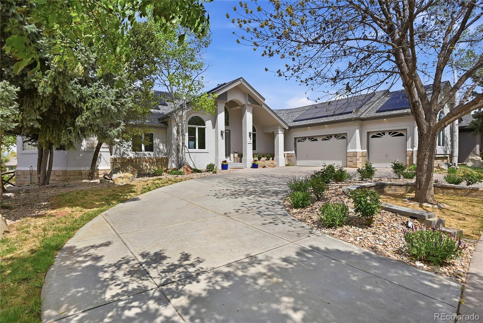 Experience elevated Colorado living in this exceptional luxury ranch-style home perfectly positioned on a private .33-acre cul-de-sac lot backing directly to the 9th fairway of Legacy Ridge Golf Course with breathtaking mountain and golf course views. Designed for both elegant entertaining and everyday comfort, this meticulously updated residence offers 4 bedrooms, 4 bathrooms, a finished walk-out basement, and an extraordinary blend of luxury, privacy, and modern upgrades.The newly remodeled chef’s kitchen is a true showpiece featuring stunning porcelain countertops and custom cabinetry, upgraded designer lighting, and chef-inspired appliances. The open-concept layout flows seamlessly into the spacious living room highlighted by a dramatic stacked stone fireplace with custom mantel, and expansive windows framing incredible mountain/fairway views.The luxurious primary retreat offers patio access, huge walk-in closet, and spa-inspired bath complete with soaking tub, oversized shower, dual sinks, and dedicated dressing/vanity area. A custom office and formal dining room provide flexibility for work and entertaining. Downstairs, the walk-out basement features beautifully appointed secondary bedrooms. A stunning custom bathroom renovation was just completed!  The inviting gathering space with full wet bar is waiting for you.Outdoor living is equally impressive with a new maintenance-free deck, professionally landscaped grounds, mature trees, sprinkler system, and a covered lower patio featuring a pine ceiling and custom drainage system. Enjoy year-round comfort and peace of mind with radiant heated flooring throughout, a new boiler, two new AC units, whole-house water filtration system, Moen emergency water shutoff system, exterior steel shutters, solar panels, new roof, and fresh exterior paint. The home has been pre-inspected! Completing the home is an oversized 3 car garage in an unmatched setting. This is Colorado luxury living at its finest.