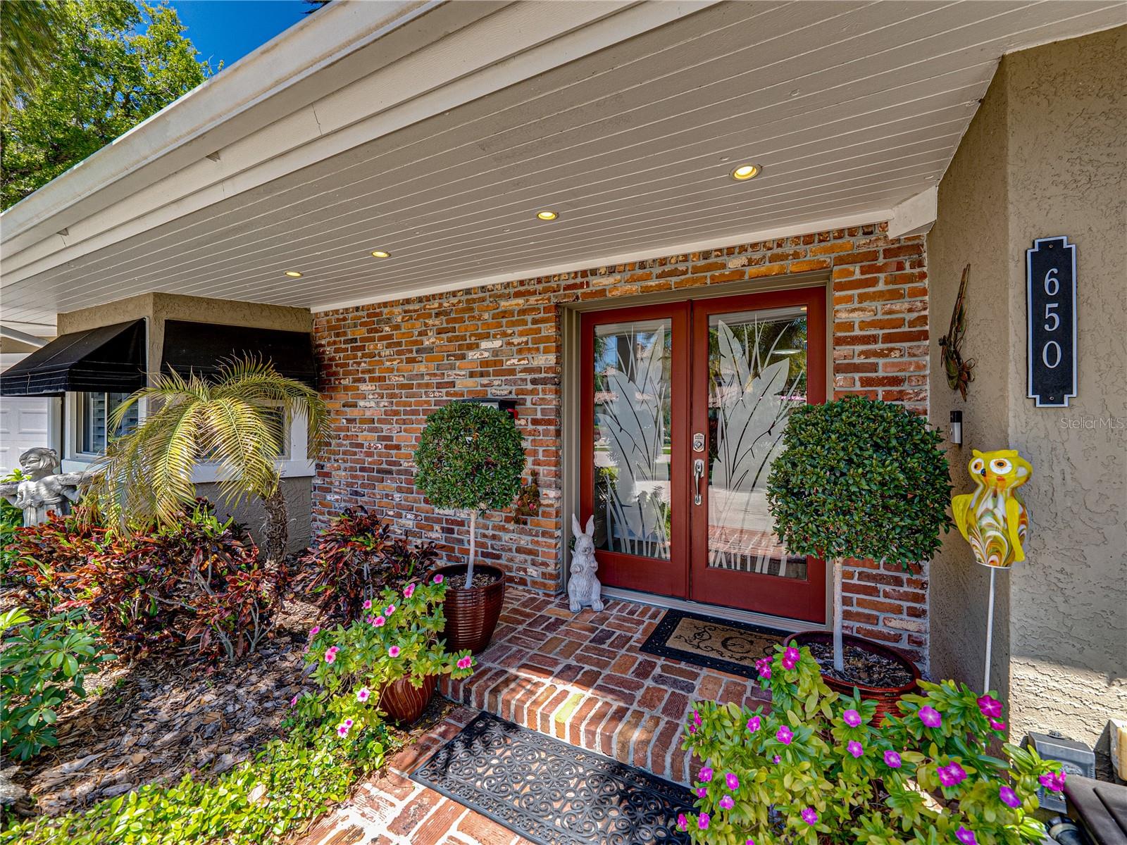 HUGE PRICE IMPROVEMENT! GOLF COURSE LIVING awaits with this beautifully updated estate home, ideally situated on the 5th fairway of the Pelican Golf Course, offering stunning views and serene Florida sunrises. From the moment you arrive, you are greeted by the home's charming exterior, vibrant landscaping, and a circular driveway that sets the tone for the exceptional spaces inside. Step into an open and bright floor plan designed with both style and functionality in mind. Soaring vaulted ceilings, with exquisite wooden beams and oversized windows throughout, fill the home with warm and natural light. At the heart of the home is the spacious kitchen, complete with beautiful maple cabinetry, SS appliances, and an expansive breakfast bar. The walk-in pantry ensures ample storage, while the intimate cafe nook offers a charming setting for casual dining. Directly off the kitchen is a private courtyard, fully fenced for added privacy (NEW PVC FENCE, April-2025). This peaceful outdoor space, accessible from both the kitchen and primary suite, offers a secluded escape perfect for enjoying your morning coffee or simply relaxing outdoors. Just beyond is the dining room, complete with a built-in wet bar, beverage refrigerator, and additional bar seating. It provides the ideal setting for both intimate soirées and grand celebrations. Adjacent to the dining room is a tranquil alcove that offers a cozy space to unwind. The family room showcases a magnificent stone fireplace providing an inviting space for conversation or relaxation, with large windows framing sweeping views of the golf course that brings the outdoors in. The primary suite is thoughtfully positioned on the left wing of the home, ensuring maximum privacy. This luxurious retreat boasts oversized windows, dual closets (A custom Walk-Through closet & an additional spacious custom Walk-In closet with direct access to the courtyard), and a beautifully renovated ensuite bathroom. This luxurious ensuite features a sleek, freestanding soaking tub, dual vanity sinks, and a generously sized walk-in shower, providing a true sanctuary. Three secondary bedrooms: The front bedroom is appointed with custom built-in dresser drawers and a custom walk-in closet, that share a charming Jack-and-Jill bath with the second bedroom. The third bedroom, located at the rear of the home, is oversized and host 2 closets. Although, it is currently being used as a cozy den it could easily function as a second primary suite or an in-law suite, with a full bath that is just steps away. The private backyard oasis is encased by a charming white picket fence and offers panoramic views of the fairways. This quiet haven offers the perfect setting for both grand gatherings or just watching golfers pass by. **NOTABLE MENTIONS: This home sits 45+ feet above sea level, NO FLOOD ZONE, NO FLOOD INSURANCE REQUIRED, Situated on the 5th Fairway, Double-Pane Windows, Storm Shutters, Plantation Shutters/Honeycomb Blinds, Electrical Panel Wired for a Generator, NEW A/C (2023), NEW Roof (April 2025), NEW PVC Fence (April 2025), NEW HOT WATER HEATER (April 2025), Workshop & ½ Bath in Garage, & so much more! Call today for a private tour of this exquisite, 'worry free--stress free' home & start enjoying all the amazing things that Belleair has to offer. Just around the corner from the prestigious Pelican Golf Country Club, sugar-white Gulf beaches, fine dining, fabulous boutiques, and just a few minutes from Tampa International Airport.