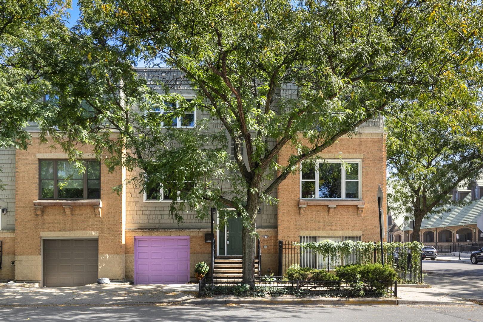 Discover this meticulously upgraded, sun-drenched fee-simple townhome offering an exceptional alternative to a single-family residence. The main level features an open-concept floor plan, where a spacious living room with a gas fireplace flows seamlessly into a designer kitchen. Fully remodeled in 2022, the kitchen is appointed with Snaidero cabinetry, Cambria quartz countertops, a Miele gas range, built in microwave and built-in refrigerator, and a Cove dishwasher. A custom-built dining banquette provides both style and storage. From the kitchen, step out onto a large private deck, one of two generous outdoor spaces. The upper level is dedicated to comfort and privacy. The king-sized primary suite boasts a custom-designed walk-in closet and a beautifully remodeled (2023) en-suite bathroom, featuring a two-person walk-in tub, a separate shower, and a floating vanity with quartz countertops. Two additional bedrooms and a second full bathroom complete this floor. The versatile lower level includes a multi-functional family room, a fourth bedroom, and a third full bath. Newer French doors provide direct access to the private yard. This home is equipped with extensive technological and system upgrades, including a tankless water heater, a Samsung Bespoke All-In-One washer/dryer, and a comprehensive smart home system featuring Lutron, Ecobee, Schlage, and Hunter Douglas controls. With no HOA fees and two separate garages (one attached, one detached), this property is a rare find. Perfectly situated near parks, shopping, and dining, with easy access to the CTA Blue Line and I-90/94 for effortless commuting.