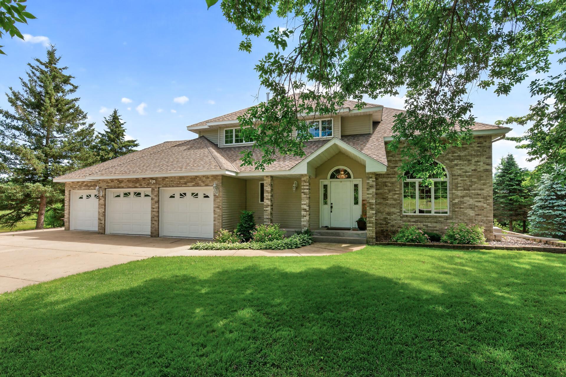 Privately set at the end of a quiet paved road on 3 acres, this custom-built two-story is the rare blend of privacy, space, and pride of ownership. Inside, 3,505 finished square feet flow from a vaulted great room into an eat-in kitchen and formal dining, with hardwood floors, a jetted-tub primary suite, and a lower level made for entertaining. Three fireplaces warm the home - two showcasing custom Terry Redlin etched-glass art you won't find anywhere else. Recent updates mean you can simply move in: brand-new carpet, fresh epoxy floors in the 3-car garage, newer HVAC, and a roof with 50-year shingles and a transferable warranty. In-ground sprinkler keeps the expansive yard lush, and mature trees offer year-round seclusion. Lovingly maintained and ready for its next owner - come see what this Monticello acreage property has to offer.