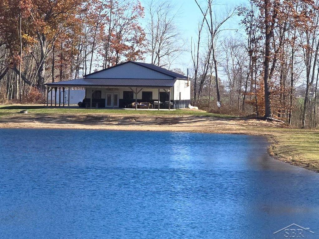 ADDITIONAL LAND INCLUDED - Stunning New Construction on a Massive Sand Ridge, Huge Private Spring Fed Pond, 21.36 Acres, Gourmet Kitchen with Stainless Appliances, Quartz Counter Tops and Spacious Breakfast Island, Amazing 20' Ceilings Thru-Out, Heated 5-inch Thick Concrete Foundation (separate thermostats for home and barn), 55' long, 15' wide Covered Wrap Around Patio with Sandy Beach Just Steps Away. Peace & Tranquility Are Waiting For You - Escape, Relax & Recharge!!   ***for aerial view, go to Realtor.com and click on "Fly Around" ***