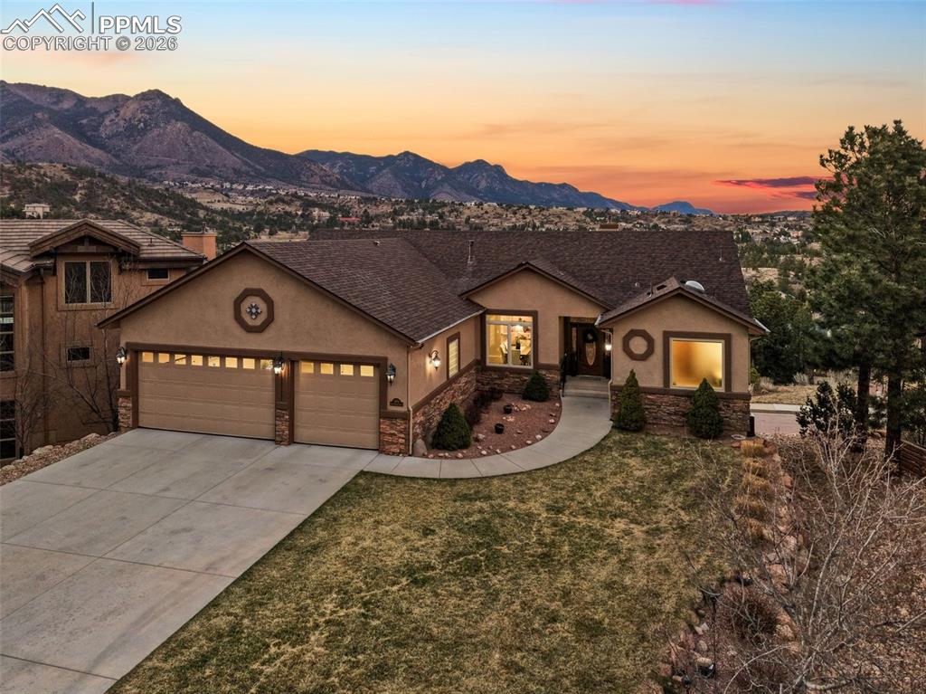 Located in the highly sought-after Sanctuary at Peregrine, this meticulously maintained ranch-style home offers sweeping, unobstructed city & mountain views from nearly every window. Perfectly positioned to capture Colorado’s incredible scenery, 2 expansive decks span the entire back of the home, creating stunning outdoor living spaces ideal for entertaining or relaxing while taking in breathtaking sunsets & sparkling city lights. Inside, the home offers desirable main-level living with an open, light-filled layout designed to highlight the views. Recent updates including freshly painted rooms, updated light fixtures, & a newly installed kitchen backsplash have beautifully refreshed the main level & create a modern, move-in ready feel. The kitchen flows seamlessly into the dining & living spaces where vaulted ceilings & large windows frame the spectacular backdrop beyond. The main level includes 2 bedrooms, including a spacious primary suite. The expansive walk-out basement with soaring 9 ft ceilings provides exceptional space for guests or entertaining with a large rec room, additional bedrooms, & access to a covered lower deck. A newer hot tub is perfectly positioned to enjoy the peaceful setting & dramatic views. Outdoor living is exceptional. The composite decks provide front-row seats to mountain vistas & sparkling city lights. The HOA maintains the lawn, grounds & snow removal, allowing for an easy low-maintenance lifestyle. Additional highlights include a brand new Class 4 impact-resistant roof installed March 2026, radiant heated floors in the kitchen eating area, primary bath & main-level guest bath, updated joists on the main-level deck, a spacious 3-car garage, & meticulous care from the original owners. Located in Academy District 20 near parks, trails, shopping, & highly regarded Woodmen Roberts Elementary. Homes with views like this rarely become available in Peregrine. Schedule your private showing today.
