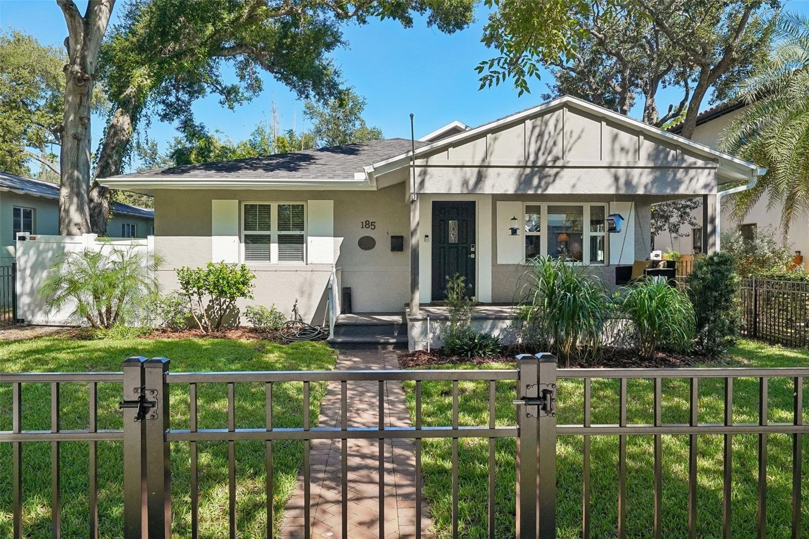 Timeless charm meets beautifully renovated living at 185 24th Avenue North in St. Pete’s sought-after Old Northeast. This gorgeous two-story bungalow offers five bedrooms, three full bathrooms, a two-car garage, and a heated saltwater pool in a prime location just two blocks from Coffee Pot Bayou. Refinished wood floors bring warmth and character throughout, while a new roof installed in 2026 adds peace of mind. High and dry, the property is located outside the flood zone and evacuation zone. The beautifully updated kitchen features new stainless-steel appliances, white solid-wood Shaker cabinetry complemented by accent cabinetry, and granite countertops. Upstairs, the newly constructed primary suite provides a spacious private retreat with vaulted ceilings, a large walk-in closet with built-ins, an en-suite bathroom featuring a double vanity, an adjoining bonus room ideal for a home office, and a private balcony overlooking the pool. A screened first-floor lanai offers the perfect spot to relax or entertain while overlooking the inviting heated saltwater pool and private backyard with new vinyl fencing. Enjoy waterfront walks along Coffee Pot Bayou, where manatees and dolphins are often spotted, or stroll toward downtown St. Pete to explore its restaurants, shops, parks, and vibrant arts scene. With its thoughtful renovations, historic character, and exceptional location, this Old Northeast home captures the best of St. Pete living.