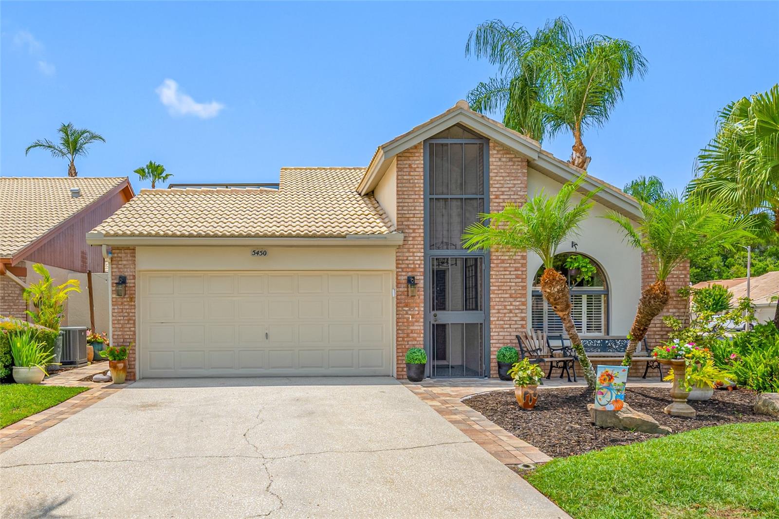 Welcome to your own private sanctuary in the desirable gated community of Chattam Landing at Ridgemoor.   This beautifully updated 3-bedroom, 2-bath corner-lot home features an OPEN FLOOR PLAN with soaring vaulted ceilings, abundant natural light, and four sets of French doors that seamlessly connect the living spaces to the courtyard-style pool area.  With over $130,000 in recent upgrades, this move-in-ready home offers a unique blend of style, comfort, and functionality.   The completely REMODELED KITCHEN opens to the dining and living areas and showcases leather-finish granite countertops, an extended breakfast bar, custom 42-inch wood cabinetry with soft-close doors and drawers, stainless steel appliances, & LED lighting.   This home's relaxing ambience is accentuated by its NEW ELECTRIC FIREPLACE & custom designed surround in the living room.   The primary suite offers a spacious EXTENDED WALK-IN CLOSET and a SPA-INSPIRED BATH with dual sinks, quartz countertops, and a zero-entry walk-in shower with floor-to-ceiling tile & river rock floor.  The secondary bath features a Safe Step hybrid walk-in tub and shower with hydro jets, aromatherapy, & heated seating.  Designed for year-round enjoyment, the PRIVATE OUTDOOR OASIS includes a SCREEN ENCLOSED COURTYARD POOL with new surface and tile surround, solar heating, Timber Tech composite decking, shade sails, & salt chlorinator.   The lanai area features an electric fireplace, custom bar area with sink and refrigerator, and inviting spaces for relaxing or entertaining!    The third bedroom has been transformed into a flexible espresso/wine lounge with built-in coffee station, wine fridge, & sleek wood slats giving it a Zen like feel.   Can easily be converted back to a bedroom.  The two-car garage has been professionally designed and provides the perfect workspace with epoxy flooring, butcher block countertops, steel cabinetry, ceiling-mounted storage racks, & slat wall organization.   New water heater & new water softener in 2024.  HVAC system replaced in 2018.  TILE ROOF REPLACED 2016.    Don't miss this opportunity to make this one of a kind home your own!