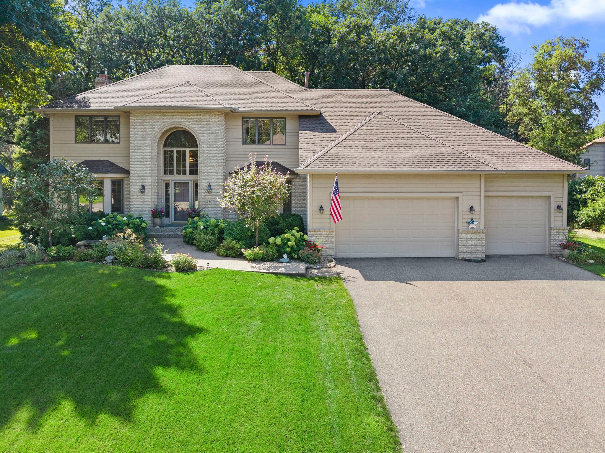 Welcome to this beautifully maintained 4-bedroom, 4-bathroom home nestled in a quiet Lakeville cul-de-sac. Ideally located near Orchard Lake and Prairie Lake Park, Brackett’s Crossing Country Club, and a variety of shopping, dining, and local amenities, this home offers comfort and convenience in a desirable location. The welcoming foyer features impressive 18-foot ceilings and hardwood flooring. The spacious kitchen offers abundant cabinetry, hardwood floors, newer stainless steel appliances including a double oven, granite countertops, a large center island with built-in cooktop, and a 6x3 pantry. The kitchen flows into the informal dining area with walkout access to the spacious patio and private, tree-lined backyard. A separate formal dining room features a bay window and stunning chandelier. The family room offers pocket doors, a cozy gas-burning fireplace with brick surround, and built-in cabinetry. A bright sunroom provides additional living space and patio access, while the front living room adds even more flexibility. The main level includes a spacious handicap-accessible bedroom with wide doorways, hardwood floors, a 8x6 walk-in closet with built-ins, and a private tile ensuite with roll-in shower and grab bars. A convenient laundry room and half bath are nearby, while the three-car garage includes a wheelchair lift. Upstairs, the spacious primary suite features a tray ceiling, large window, and private ensuite with a 10x7 walk-in closet, oversized jetted tub, dual vanities, separate water closet, and walk-in tile shower. Two additional bedrooms with walk-in closets share a full Jack-and-Jill bathroom with individual vanities.The unfinished lower level offers additional storage and future finishing potential. Recent updates include newer sliding glass doors and kitchen windows, replacement of windows along the back and side of the home, and a new roof, gutters, and downspouts in 2025. Don’t miss this opportunity to own a spacious, thoughtfully designed home with accessibility features,  updates, beautiful outdoor spaces, and a peaceful Lakeville setting.