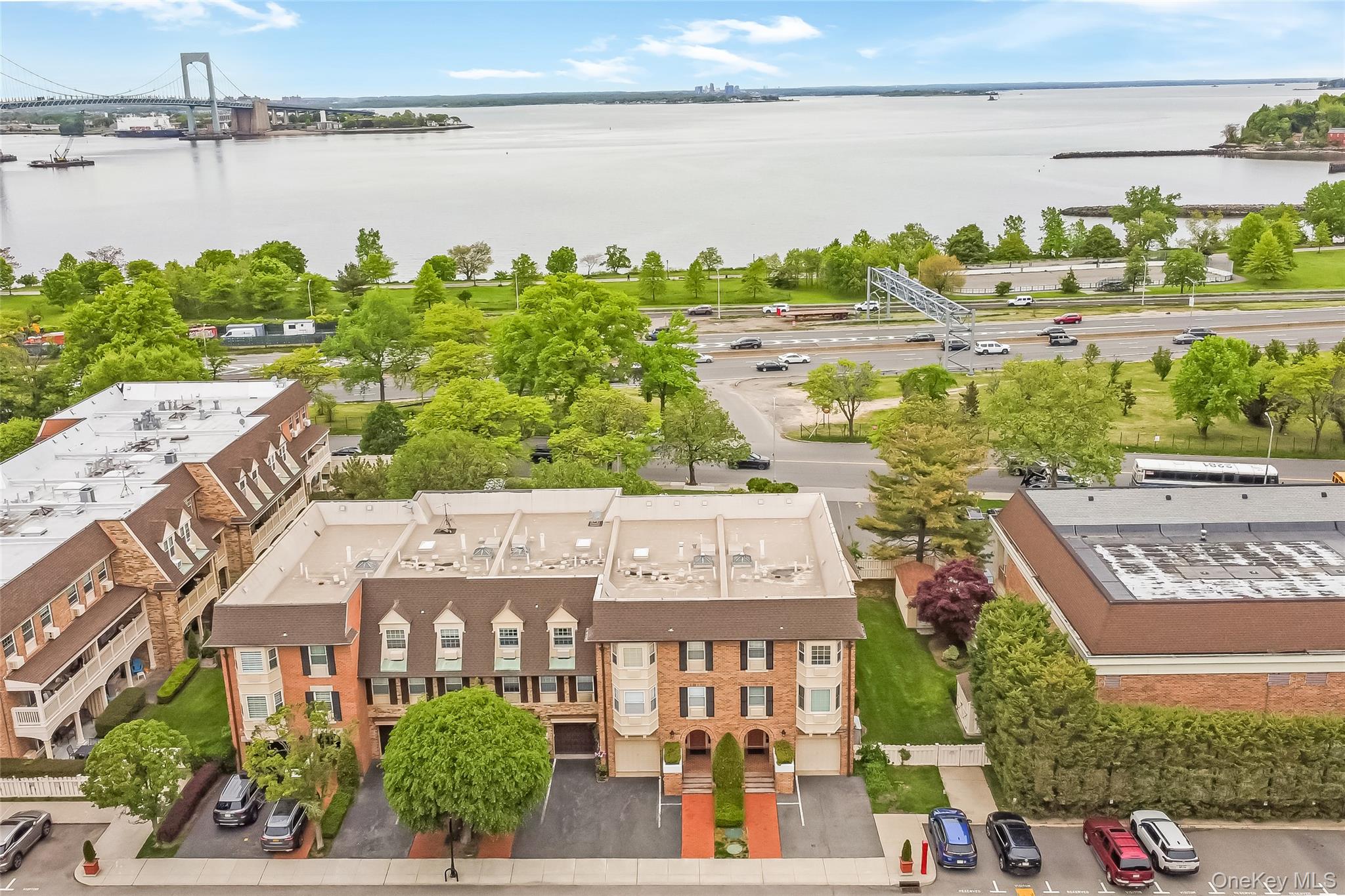 Rare opportunity to own one of the few Baybridge condominiums offering stunning water and bridge views. This deluxe two-bedroom residence features an open-concept layout with a spacious chef-style kitchen complete with a center island, perfect for entertaining.The primary suite offers a full private bathroom with a luxurious oversized shower. Hardwood floors run throughout the home, and the convenience of an in-unit washer and dryer adds to the ease of everyday living. The unit also includes a private garage and driveway parking for two vehicles, along with additional storage located in the common basement area. This secure gated community offers exceptional resort-style amenities including a year-round indoor pool, outdoor pool, state-of-the-art fitness center, tennis courts, basketball courts, pickleball courts, and community meeting rooms. Residents also enjoy Sunday brunch gatherings that enhance the vibrant community lifestyle.