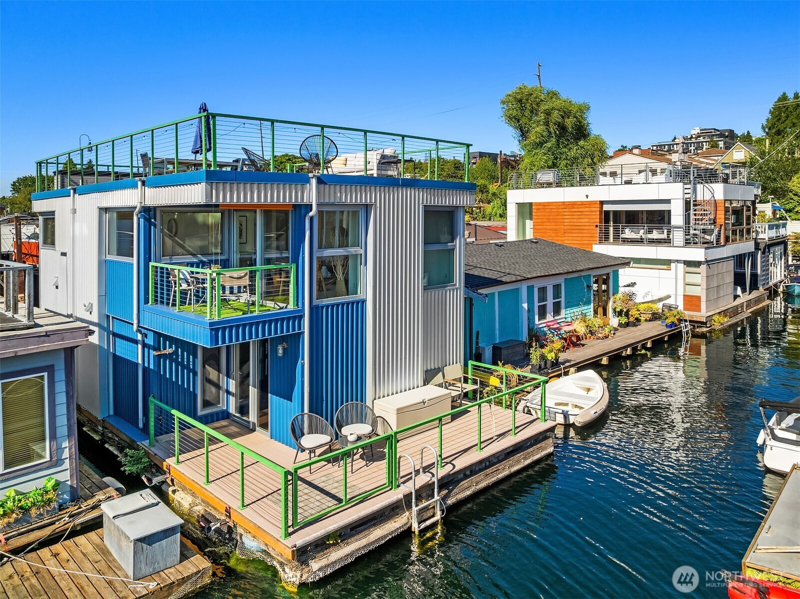 Life really is better on Lake Union! This 2 bedroom, 1.5 bath sunny, south-facing floating home features a well-designed reverse floor plan that maximizes views and leads to a grand rooftop deck with stunning city skyline, lake, and mountain vistas. Contemporary in style, it offers beautiful hardwood floors, built-ins, and a cozy gas fireplace. The spacious kitchen includes a walk-in pantry, and the primary suite—lined with closets—is truly a dream. Start your day with a swim from the large first-floor deck, dip your toes in the water, or kayak to your favorite coffee shop. Steps to groceries, Eastlake shops, and restaurants. Now is the time to join us on the lake!