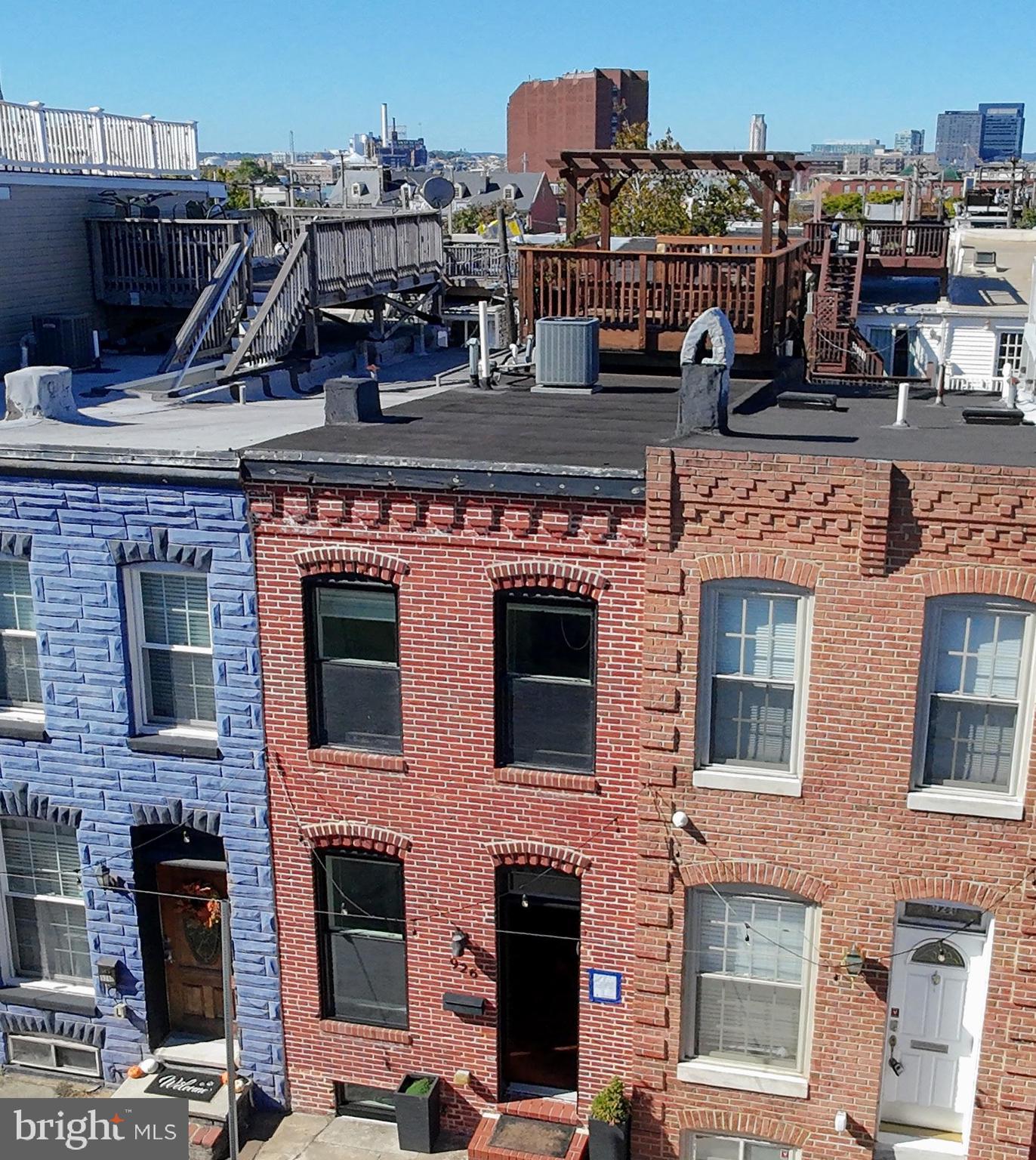 Welcome to this beautifully maintained and freshly painted three-bedroom, three-bath home located in one of Baltimore’s most sought-after neighborhoods. The main level features a bright, open layout with a modern kitchen equipped with everything you need for cooking and entertaining. From the kitchen, step directly outside to your private parking pad for added convenience.Upstairs, you’ll find two generous bedrooms and two full baths, including a primary suite with an attached bathroom. The second bedroom features a walkout balcony that leads up to your private rooftop deck, ideal for relaxing or entertaining while enjoying sweeping city views.The fully finished lower level offers a spacious bedroom with a full stand-up shower and additional storage space—perfect for guests or a home office.Don’t miss the opportunity to call this move-in-ready Canton gem your new home!