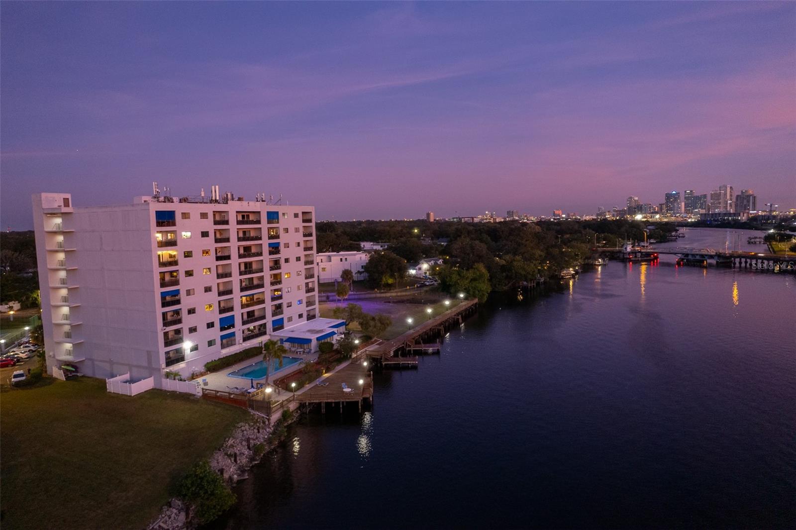 Completely renovated waterfront condo in the highly desirable neighborhood of Riverside Heights, and less than a block from the upcoming Riverwalk extension at Columbus Drive. Enjoy sunset from the private balcony of this top floor, three bedroom, two bath end unit. Recent major remodel includes new kitchen, bathrooms, flooring, doors, trim, hardware and fixtures, impact sliding doors and windows, and so much more. Enter into a central hallway and notice that the ceiling was raised to create a more open and modern feel, a rare improvement in the building. To the left is the first guest bedroom and the guest bathroom, which features an extended vanity and shower/tub combo. Further down on the right is the primary suite which features a large bedroom plus attached bonus room perfect as an office, nursery, or workout space. The primary bathroom features a double vanity and glass-enclosed shower, and a walk-in closet with custom shelving. The beautiful open kitchen features new, modern stainless steel appliances, quartz counters, premium cabinets with soft close, and a tiled backsplash, and is open to an enormous living and dining space. The 3rd bedroom, currently used as an office, is accessed through French doors and has water views and its own balcony access. The kitchen and adjacent living spaces are all open and expansive, creating a comfortable space for both private life and social gatherings. The private balcony with views of the river and Downtown Tampa is perfect for morning coffee or sunset cocktails, and also includes a private storage closet. There is a large pantry and laundry room just off the kitchen. The fully gated community features a pool and clubhouse with sauna, 350’ waterfront boardwalk with transient boat slips, recently refinished tennis and pickleball court, and a dog park. Included with Unit 805 is a deeded and dedicated covered garage parking spot, which is a coveted asset in the building, and can be sold or transferred. The community also provides a personal storage locker and a bike-storage room, and dedicated area for owners to park boat trailers or RVs. Convenient location just minutes from Armature Works and a brand new Publix, Downtown Tampa and Ybor City, Tampa International, and more. Contact a Realtor to schedule a showing today!