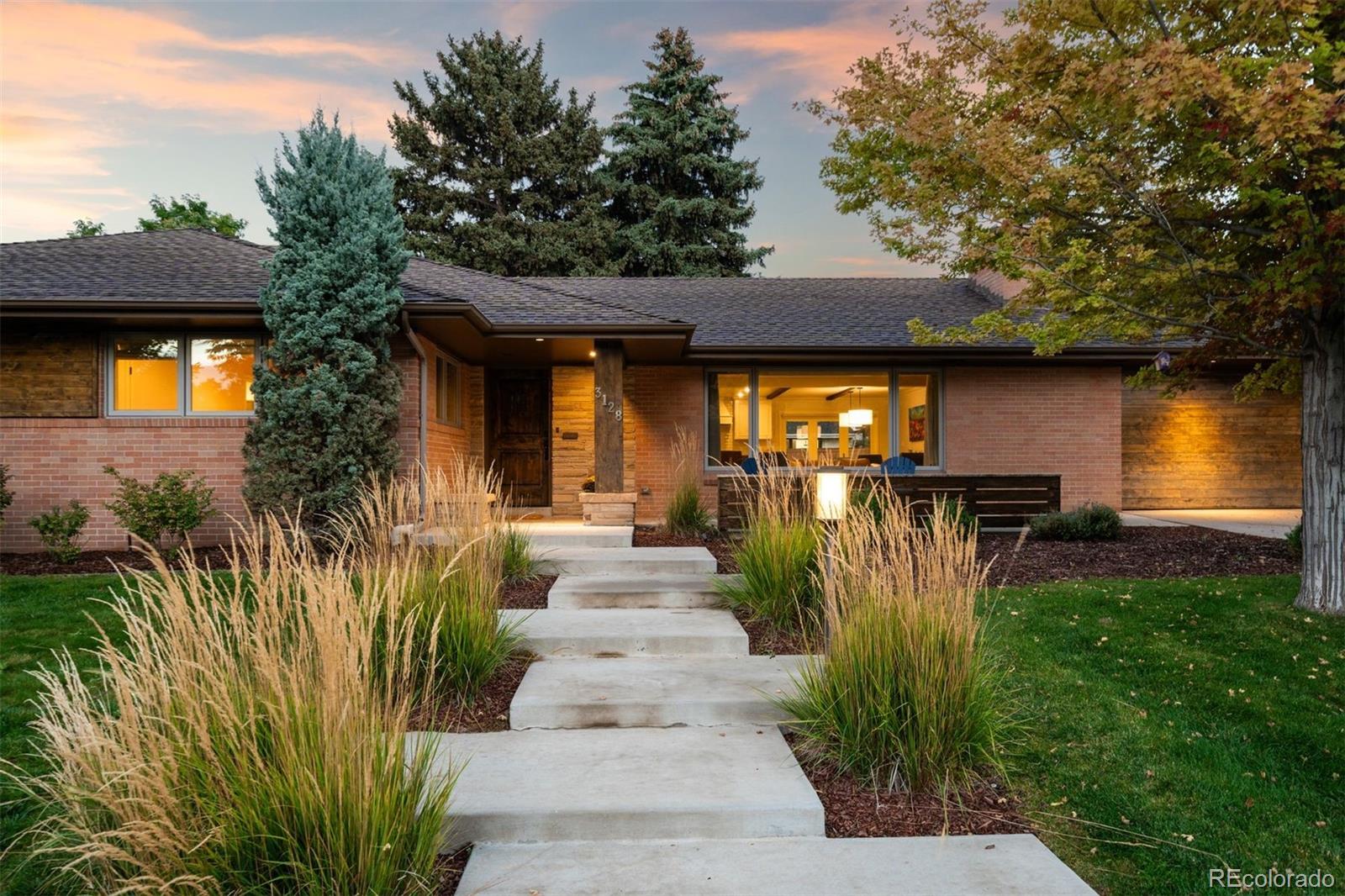 Spanning 4,047 total sqft and a short 4-minute walk to Slavens, this ranch-style home on an extensive lot offers five bedrooms and a dedicated office, capturing the essence of Wellshire living: quiet streets, generous space, and lasting character. Ascend the layered front path to an inviting front patio. Upon entering the main living area, a full wall of west-facing windows brings in natural light, capturing evening sunsets. A statement stone fireplace & custom built-ins anchor the room. The kitchen & dining areas carry the same character forward. Exposed wood beams & intricate detail add texture, while leathered granite countertops, a farmhouse sink, custom hood, and oversized island create a kitchen balancing form & function. The adjacent walk-in pantry & coffee bar are thoughtfully incorporated, adding additional prep space. A dedicated dining area sits alongside the centerpiece island, positioned to connect directly to the backyard. The large rectangular lawn is ideal for outdoor play & recreation. Whether it’s a game of soccer or a friendly badminton match, there’s space for it all! A pergola-covered patio offers shade, while an elevated deck creates additional gathering space, complete with a hot tub. The main level is anchored by a true primary suite with deck access, a five-piece bath featuring dual vanities, a walk-in shower, a soaking tub, and an oversized walk-in closet. Two additional bedrooms & a full bath sit on this level, along with a private office behind dramatic French doors. The finished basement provides expansive additional living space with flexibility for media or hosting, and is pre-plumbed for a future wet bar. Two additional bedrooms with egress windows and a ¾ bathroom offer comfortable guest accommodations. Moments to Wellshire Golf Course, this is a rare offering in one of Denver’s most sought-after neighborhoods.