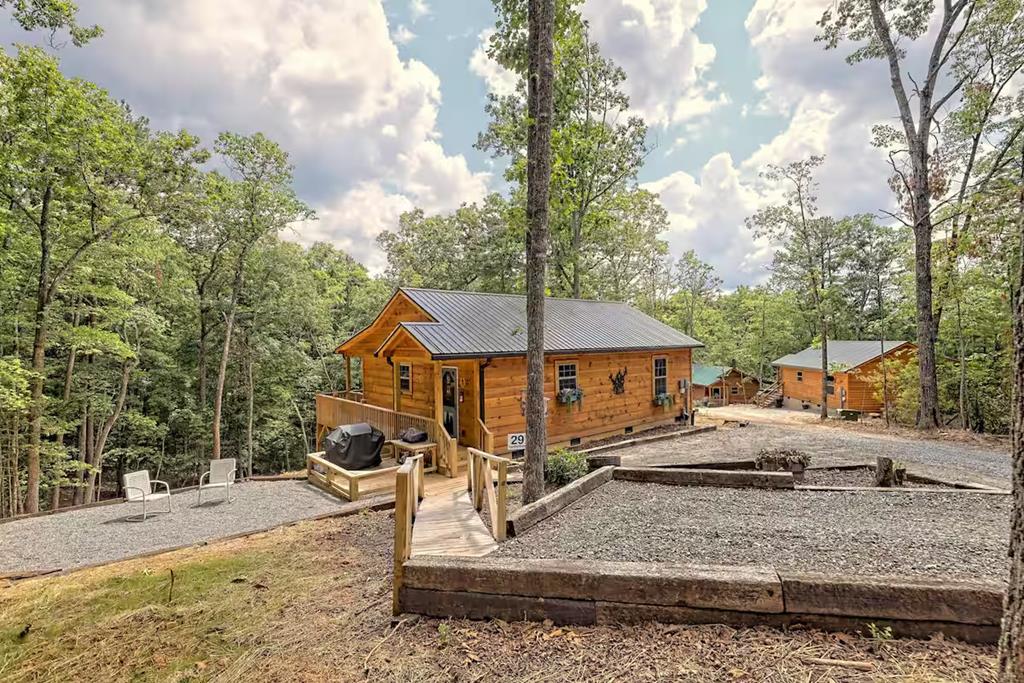 Turn-key and completely ready to go, this charming cabin is being sold fully furnished—right down to the smallest details—making it the perfect investment opportunity or personal retreat. Currently operating as a successful vacation rental with a proven income history, it's ready to generate revenue from day one. Inside, you'll find a warm and inviting all-wood interior with soaring vaulted ceilings that create an open, airy feel. Thoughtfully designed and beautifully maintained, the space features granite countertops, stainless steel appliances, and a functional open layout ideal for hosting guests or relaxing after a day outdoors. Cozy, cabin-style bedrooms offer comfort and charm, perfectly complementing the rustic aesthetic buyers are looking for. Step outside and enjoy expansive decking and multiple outdoor seating areas, ideal for entertaining or simply taking in the peaceful wooded surroundings. Whether it's morning coffee on the covered deck or evenings unwinding under the trees, this property delivers the full mountain getaway experience. Wanting a well-performing short-term rental or your own private escape, this one checks all the boxes—fully furnished, well-appointed, and truly move-in ready.