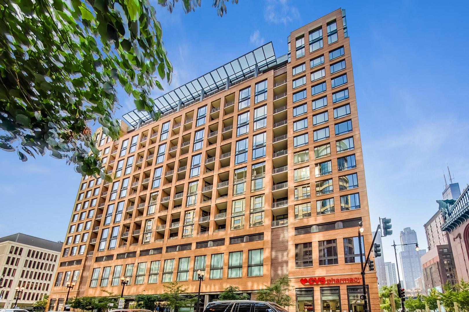 The Library Tower Condo Association; where city living meets modern comfort in the heart of Printers Row and the South Loop. This spacious one-bedroom, one-bathroom condo offers 1,080 square feet of thoughtfully designed living space with an open floor plan and contemporary concrete loft style.    The home features hardwood floors, a gas fireplace, and high concrete ceilings that create an airy and modern feel. The large kitchen is outfitted with stainless steel appliances, a generous island perfect for entertaining, and plenty of storage. The bathroom includes a Jacuzzi tub for relaxation, while the convenience of an in-unit washer and dryer makes everyday living easy. A private balcony extends your living space outdoors, and garage parking is included.    Amenities include a 24-hour door person, on-site manager and engineer, fitness center, sun deck with grills, party room, business center, theater room, and a secure package room.    The location is ideal, surrounded by the best of Chicago's South Loop and Printers Row. Step outside and you are moments from charming cafes, award-winning restaurants, Grant Park, the lakefront, the Harold Washington Library, and excellent public transportation options.    This home combines space, style, and convenience in one of the city's most walkable neighborhoods, offering a unique opportunity to enjoy the best of downtown living.