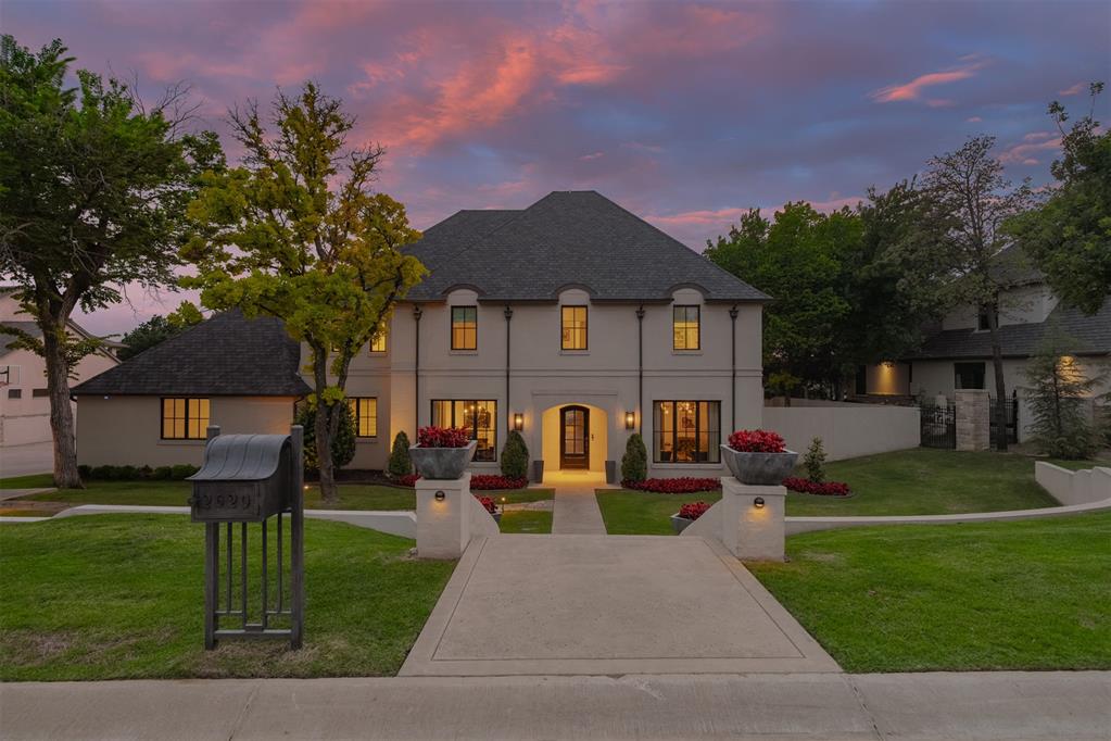 Elegant Showpiece - Impeccably designed, flawlessly maintained and truly move-in ready.  This exceptional residence showcases an expansive open-concept floor plan accented by soaring coffered ceilings, abundant natural light, and extensive hardwood flooring throughout.  Wall of windows frame serene views of the private outdoor retreat, creating a seamless connection between indoor and outdoor living.  The resort-style backyard features a stunning pool and spa, outdoor living area with cathedral ceiling, a wood-burning fireplace and a striking gas fire feature designed for elevated entertaining.  The chef’s kitchen is both sophisticated and functional, offering dual islands, double ovens, Sub Zero Frig/Freezer and additional refrigerated drawers.  The luxurious main-level primary suite is a true sanctuary.  A secondary primary suite on the main level includes the added benefit of an above-ground storm shelter.  Upstairs holds three bedrooms with ensuite bathrooms, each with its own walk-in closet accompanied by a spacious lounge area and private theater room.  Additional refined amenities include a mudroom, custom wine bar, programmable exterior architectural lighting, an integrated whole-home audio system, and a state-of-the-art security system with eight smart cameras and upgraded monitoring technology
