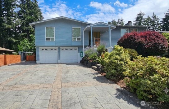 Welcome to a rare, well-maintained estate, nestled in a quiet, peaceful neighborhood on an expansive, sun-drenched 10,660 sf lot. This 3 Bd, 2.5 Ba. split level hm. radiates true pride of ownership from the moment you pull up the gorgeous, stamped concrete driveway w/Hugh RV pkg!  Step inside to find a light filled living space featuring quality, 4-way wrapped vinyl windows, plantation blinds & brand-new central air to keep you cool all summer long. The Kitchen boasts pristine newer appliances paired w/ impeccably cared for cabinetry. While a few cosmetic touches like classic carpeting and popcorn ceilings & paint await your personal style or future hardwood upgrades, the structural integrity of this home are entirely turn-key, including the lifetime metal roof! The 2-car garage has been smartly modified to feature a second kitchenette space, complete with a convenient man-door leading to a covered patio; perfect for year-round hosting, catering or hobbies.  Follow the beautiful rock staircase & expansive connecting deck to the crown jewel of the estate: a fully enclosed detached pavilion. Currently housing a sparkling swimming pool w/ brand new heating & filtration system, glass block accents & wrapped windows. This massive structure offers endless possibilities as detached future guest house, world-class media room, or the ultimate gym. Don't miss the lovely garden oasis behind the pavilion!  This is a versatile lifestyle waiting for its next chapter!