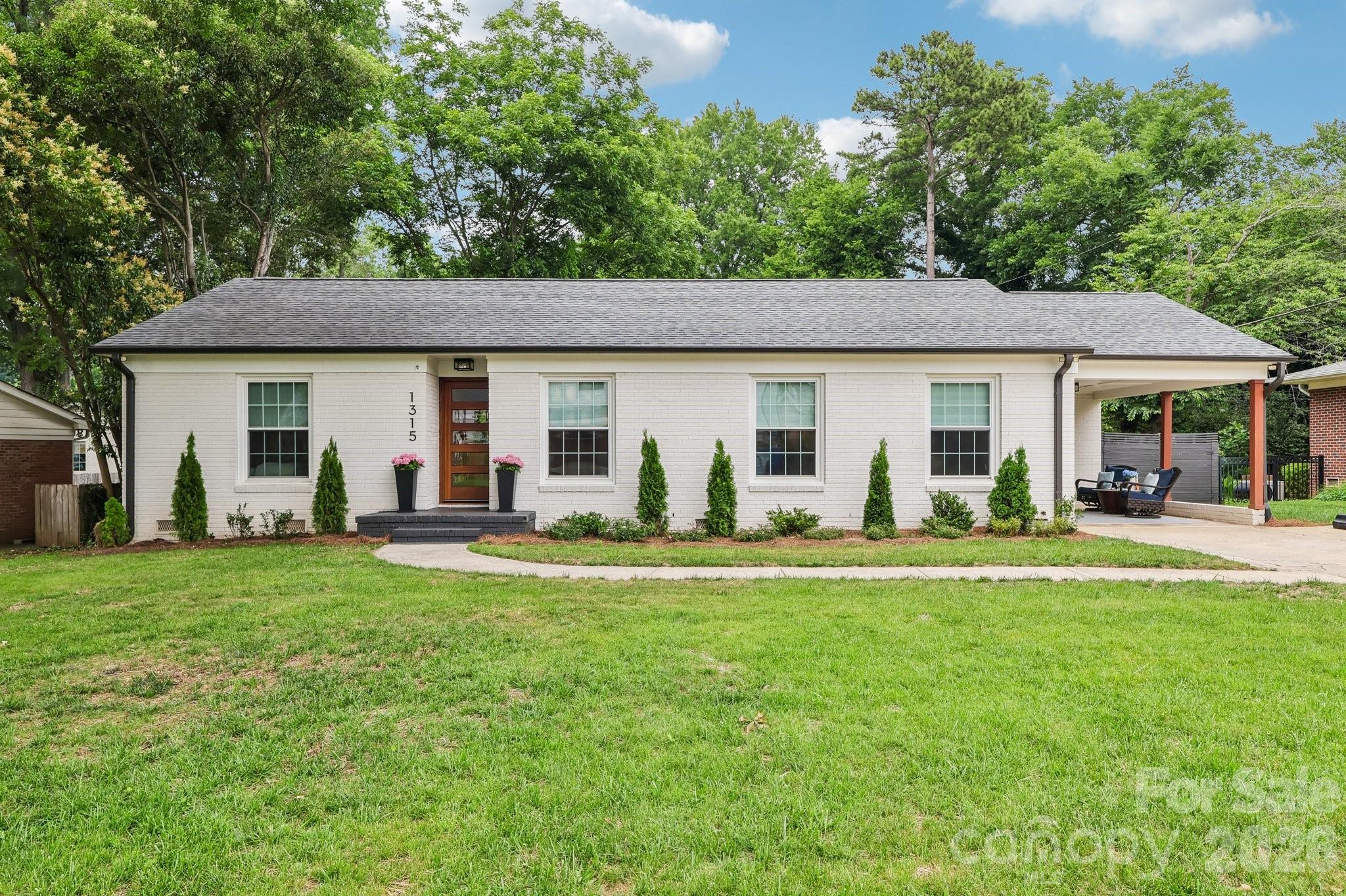 Completely reimagined and renovated, this exceptional Ashbrook residence blends timeless character, modern luxury, and an unbeatable location. Situated directly across from Park Road Shopping Center, enjoy walkable access to dining, shopping, coffee shops, and daily conveniences while being minutes from SouthPark, Uptown Charlotte, Atrium and Novant hospitals, the Light Rail, and Charlotte Douglas International Airport.Inside, approximately 2,600 square feet of thoughtfully designed living space showcases an open floor plan, hardwood floors, designer lighting, and upscale finishes throughout. The chef's kitchen features custom cabinetry, quartz countertops, a large island, double ovens, professional-grade appliances, and abundant storage.The primary suite offers vaulted ceilings, French doors opening to a private outdoor retreat, a custom walk-in closet, and a spa-inspired bath. Two additional bedrooms, including an ensuite guest suite, plus a dedicated office provide flexibility for today's lifestyle.Recent Updates: Roof 2021, Tankless Water Heater 2021, Mini split 2021, HVAC main home approximately 2017, Kitchen Aid Appliances 2021, Windows 2010 - transferable warrantyOutdoor living shines with a spacious patio, firepit, mature landscaping, privacy fencing, and multiple entertaining areas. Move-in ready and meticulously updated.
