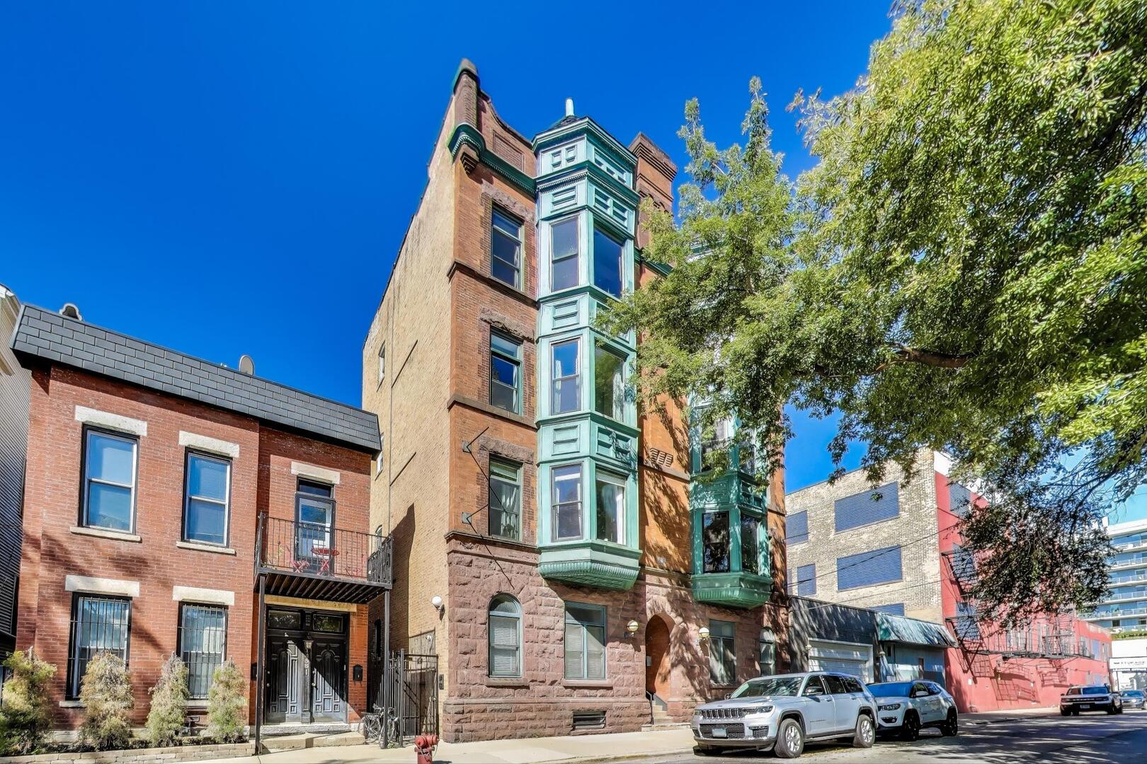 Gorgeous 2 bed, 2 bath vintage dream in historic brownstone is the perfect blend of charm and recent renovations. The spacious open floor plan features a beautiful modern white quartz kitchen, separate dining and living areas, large back patio and garage parking. The extra wide footprint allows for tons of sunlight and views of trees, fireplace with a marble surround, exposed brick and a large bay window. The stunning chef's kitchen features quartz countertops, white cabinets with designer hardware, new plumbing & lighting fixtures, stainless steel appliances and breakfast bar with seating. Great sized bedrooms; primary features a stunning, brand new ensuite bath with walk-in shower. 2nd bath also beautifully updated. In-unit laundry with brand new washer/dryer, great closet space throughout with additional storage in the basement and deeded garage parking included in price. Oversized back deck shared with one other neighbor. New HVAC 2022. The gorgeous oak floors were sanded & stained for a fresh, modern look. Modern meets vintage in fantastic Old Town location, close to Wells Street, Sedgwick brown line, North Avenue beach, Lincoln Park, Mariano's, Target and more.