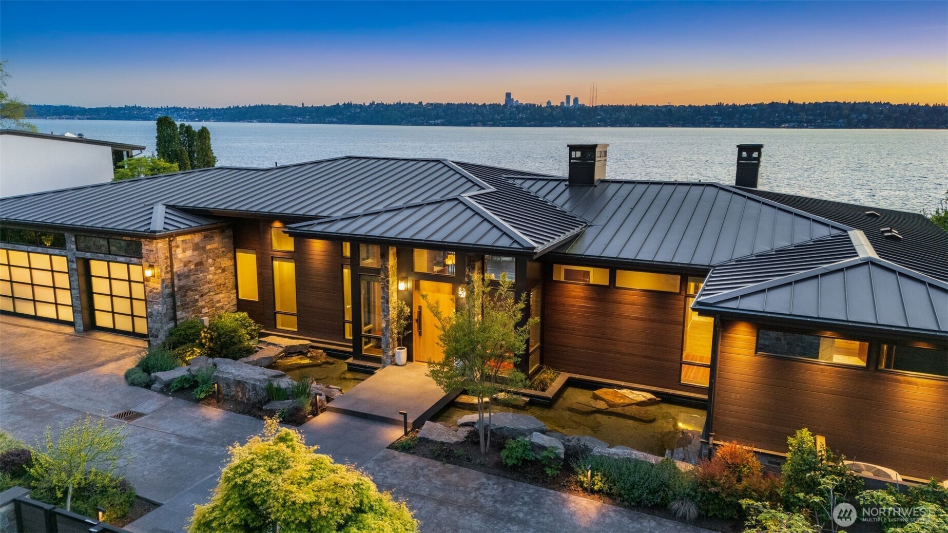 Northwest serenity at water’s edge. Prized position on Medina’s prized Gold Coast, once-in-a-lifetime property offers 144'± of pristine, irreplaceable low-bank Lake Washington shoreline. Envisioned and assembled over 6 years by the current owner, a forever home, fusing modern NW artistry & timeless luxury. Flat, shy half-acre lot w/direct, step-in lake access and expansive private dock, where views and water are woven deeply into daily life. Refined residence blends organic materials and contemporary design with seamless indoor-outdoor flow. Walls of west-facing glass capture every sunset, the glittering skyline & snow-capped Olympics beyond. Peaceful, private, and perfectly positioned between the bridges. Lakefront living, redefined.