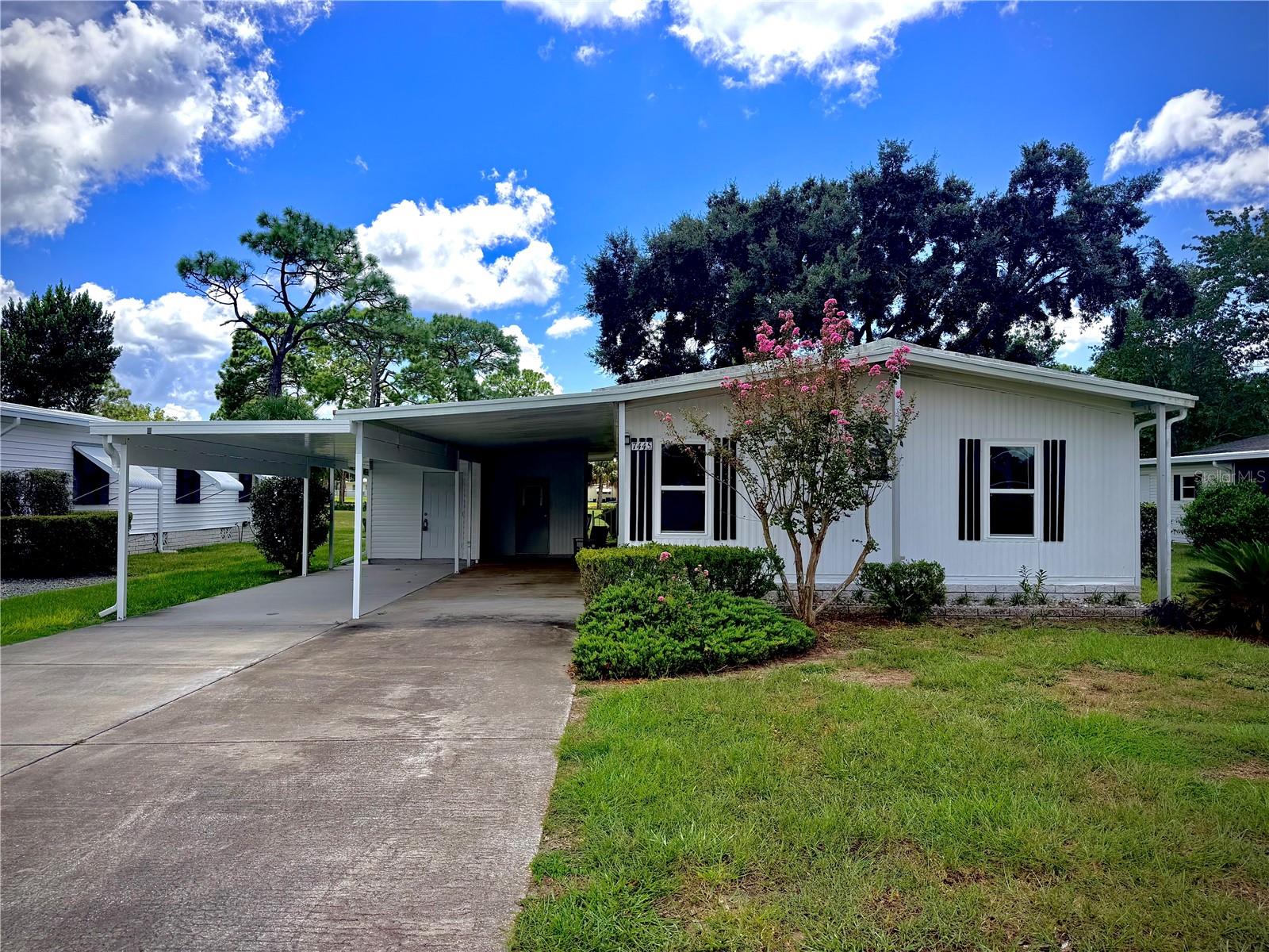 WELCOME TO FLORIDA GOLF-COURSE LIVING! Located directly on the 14th hole of Brookridge Country Club, this light and bright home offers beautiful golf-course views, abundant storage and an active 55+ lifestyle in one of Hernando County's established gated communities.From the moment you arrive, you'll appreciate the oversized driveway with recently added parking space easily accommodating multiple vehicles—plus a recently added approximately 10' x 14' storage building with electricity, providing excellent space for tools, hobbies, seasonal items or potentially, a golf cart. Step inside to high ceilings, newer windows and luxury vinyl plank flooring throughout. The recently updated kitchen offers an impressive amount of storage with white cabinetry, crown molding, beautiful backsplash, dual sink and included appliances. A dining area sits conveniently off the kitchen and opens to the comfortable living room. One of the home's highlights is the enclosed, glass sunroom overlooking the 14th hole. High ceilings, a window A/C unit and incredible views make this an ideal reading room, craft space, home office or additional entertaining area. A wall-mounted TV is already in place, and additional cabinetry and a closet provide even more storage. There's even space for a mini refrigerator to create your own golf-course-view beverage or entertaining area. Step outside to the rear patio seating area and enjoy your morning coffee while watching the golfers go by.The spacious primary bedroom is filled with natural light and features an en-suite bathroom with walk-in shower and large walk-in closet. The guest bedroom is also bright and inviting, while the updated guest bathroom features an updated vanity and glass-enclosed walk-in shower. Storage and Driveway addition added 2023/New AC and New Duct work 2024. Additional conveniences include gutters, an exterior laundry room with washer and dryer included, exceptional storage and negotiable furnishings, making this an appealing option for full-time Florida living or a seasonal retreat. Brookridge is a gated, deed-restricted 55+ golf community offering an incredible active-adult lifestyle with a heated swimming pool, clubhouse, fitness room, sauna, tennis and pickleball courts, shuffleboard, bocce, horseshoes, RV/boat storage and an extensive calendar of clubs, activities, entertainment and social events. Golf enthusiasts can explore membership opportunities at the private 18-hole, par-72 Brookridge Country Club. Conveniently located near the Suncoast Parkway, shopping, restaurants, medical facilities, Weeki Wachee Springs and Florida's Nature Coast, this home gives you the opportunity to spend less time maintaining and more time enjoying the Florida lifestyle you've been waiting for. Golf-course views. Updated interior. Exceptional storage. Active 55+ living. Welcome home to Brookridge!