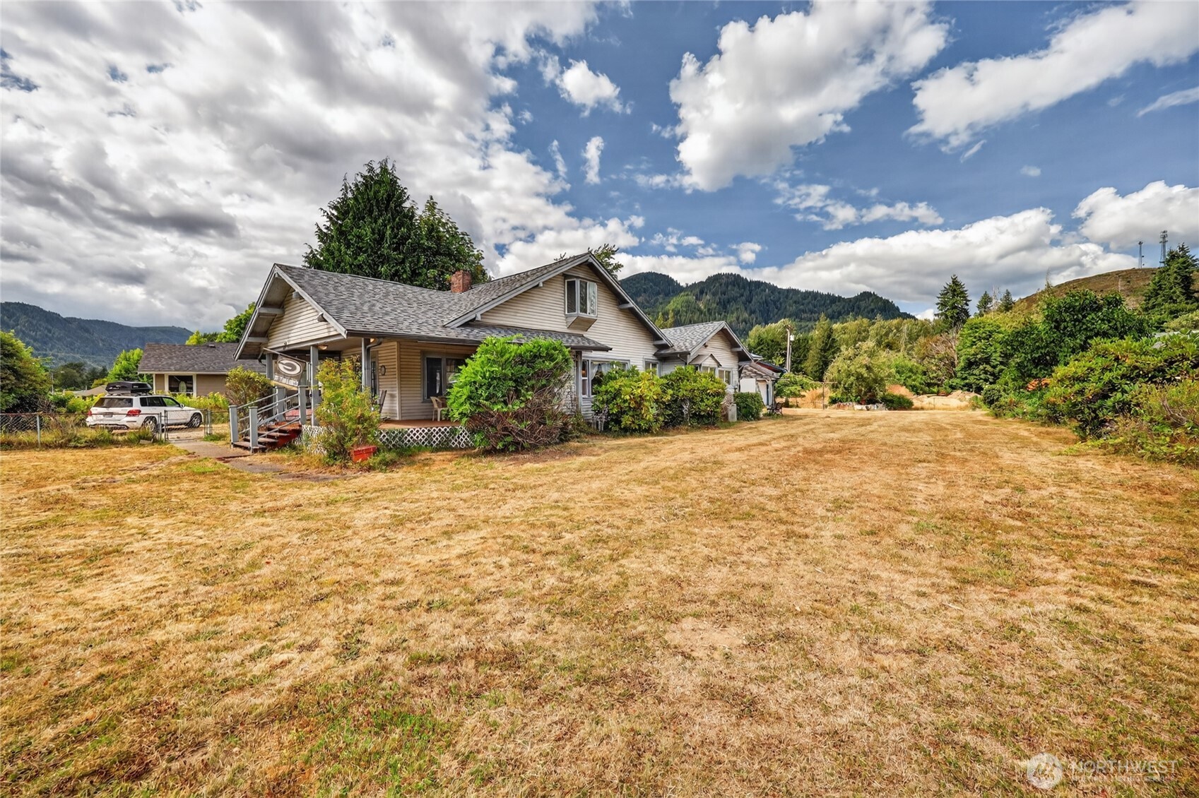 Full of character and stories from another time, this 1920's home is a true old-time treasure. From the welcoming wrap-around porch to the beautiful interior wood details, the charm of its era is still wonderfully present. The main floor features a cozy living room with propane fireplace, dining room, spacious kitchen with breakfast nook, two bedrooms, and a den that was once a third bedroom and could easily be returned to its original purpose.Upstairs, find a flexible space with 3/4 bath that leads to a balcony deck overlooking the property and nearby foothills.  Outside, the 30x30 shop offers a workroom, loft, and attached carport for gardening tools and equipment. The roughed-in basement adds even more room for storage or a workshop along with easy access to water heater, filters, etc for easy home maintenance. Set on approximately half an acre, this property has the makings of a classic garden homestead, with blueberry bushes, cherry and apple trees, and plenty of space to grow. Located next to Gus Backstrom Park and close to local amenities, it offers the best of both convenience and a little breathing room.This is the kind of home that simply isn't built anymore—a character-filled time capsule with beautiful bones, plenty of room to make it your own, and countless possibilities for its next chapter.