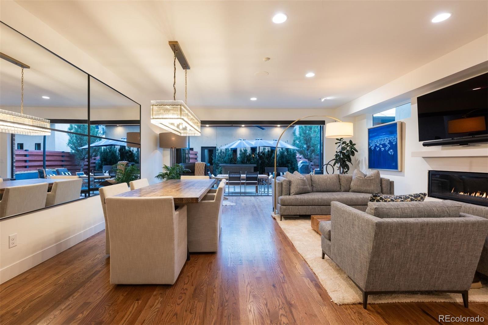 Perfectly positioned in the heart of Cherry Creek, this extensively updated contemporary residence offers a refined, low-maintenance lifestyle just moments from Denver’s premier boutiques, dining, and galleries. Thoughtfully reimagined with both design and functionality in mind, the home features light-filled interiors, clean architectural lines, and a seamless flow between indoor and outdoor living spaces. The main level centers around an open-concept living area and an updated kitchen with new countertops and a waterfall island, creating an ideal setting for everyday living and entertaining. Throughout the home, recent improvements elevate both comfort and performance, including updated RH lighting, integrated whole-house sound, automated power shades, and a whole-house humidifier. The upper level is highlighted by a fully remodeled primary suite featuring a spa-inspired bath with a soaking tub, steam shower, heated floors, and high-end fixtures. Additional bedrooms and flexible spaces accommodate a variety of living needs. A standout feature, the rooftop deck has been reimagined as a private outdoor retreat, complete with a hot tub and designed for year-round enjoyment. Seamlessly connected to a wellness/flex space, it offers a rare extension of living and entertaining space in the city. The finished lower level adds versatility with hardwood flooring throughout, a refreshed wet bar, and a custom 400+ bottle wine cellar with upgraded cooling system. Additional upgrades include new window wells, refinished hardwood floors, new carpet, fresh paint throughout, and thoughtful design enhancements across every level.Offering the ease of an attached residence with the level of finish and upgrades typically reserved for custom homes, this property presents a rare opportunity in one of Denver’s most sought-after neighborhoods.