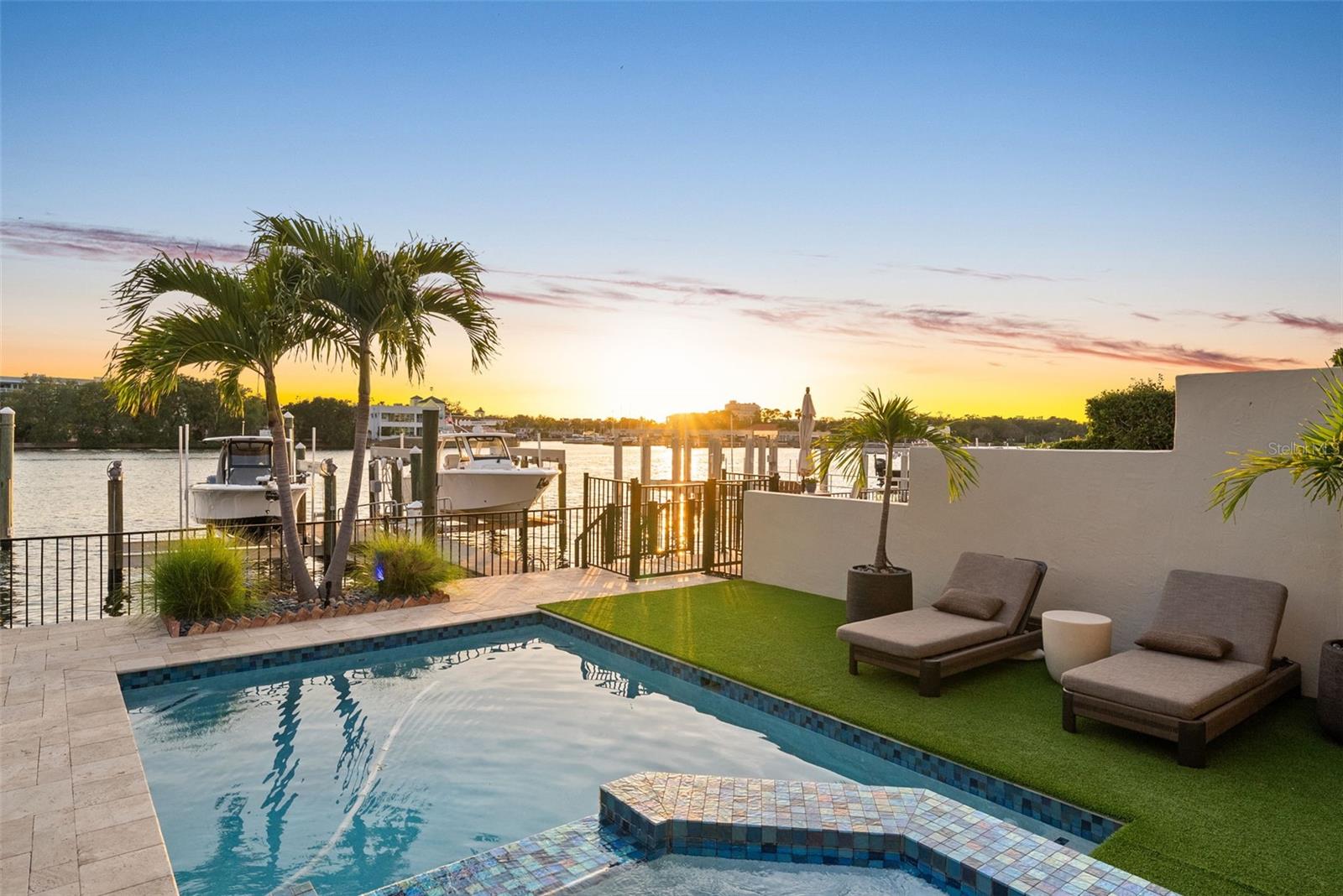 Completely redesigned luxury waterfront residence on prestigious Harbour Island offering the pinnacle of casual sophistication and resort-style living in the heart of Tampa. Deep-water accessto Tampa Bay and the Gulf with private boat slip, new 20,000-lb boat lift, and spectacular daily sunset views. Expansive indoor/outdoor living with over 4,000 SF designed for entertaining,featuring a private pool, spa, covered lanai with sunshade, second-floor balcony, and exceptional privacy within a 24-hour guarded gated community. Thoughtfully reimagined interiorshowcases open-concept living spaces, stylish work-from-home nooks, and seamless flow from elegant entry to the stunning chef’s kitchen and great room. Gourmet kitchen features Wolfand Sub-Zero appliances, oversized drawer storage, walk-in pantry, coffee bar, and spacious dining area. Step outside to a waterfront paradise complete with built-in Wolf outdoor kitchen,poolside lounging, and direct boating access. First floor includes a private guest suite or fitness room with adjacent full bath. Upstairs offers three additional bedrooms, three full baths, laundryroom, and a luxurious primary retreat with private covered balcony and captivating water views. Spa-inspired primary bath features split vanities, abundant storage, and an Asian-inspiredsoaking tub/shower room. Secondary bedrooms are thoughtfully separated for maximum privacy. Recent upgrades include pool, outdoor kitchen, windows, doors, and boat lift. Oversizedair-conditioned garage accommodates two large vehicles with abundant storage. Harbour Island residents enjoy unmatched convenience just moments from Water Street, Sparkman Wharf,Tampa Riverwalk, Bayshore Boulevard, Amalie Arena, premier dining, entertainment, I-275, Selmon Expressway, and only 15–20 minutes to Tampa International Airport. Move right in and enjoythe waterfront lifestyle you’ve always imagined.
