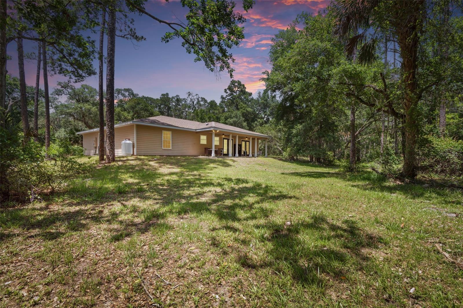 Trade traffic for trees, neighbors for nature, and stress for star-filled nights.Your private country retreat is waiting.If you've been searching for acreage, privacy, and the freedom to truly enjoy your property, this is the one.Nestled on 5.5 peaceful acres along historic Old Brick Road, this custom 2016 home offers the rare combination of modern comfort and wide-open space. Wake up to birds singing instead of traffic, enjoy coffee while watching wildlife from your porch, and spend evenings under endless Florida sunsets—all while remaining just 7 miles from shopping, restaurants, and everyday conveniences.Whether you dream of a hobby farm, a place for your boat and RV, room for children to explore, or simply a quieter way of life, this property gives you the space to make it happen.Features You'll Love  5.5 private acres with plenty of room to roam  Built in 2016 4 Bedrooms | 3 Bathrooms | Bonus Room Two en suite bedrooms—ideal for guests or multi-generational living Spacious open floor plan filled with natural light Viking propane range with matching hood Real wood cabinetry Luxury vinyl plank & tile flooring throughout (no carpet) Oversized primary suite with French doors and two walk-in closets No HOA Bring your boats, RVs, trailers, toys, and animals Approximately 7 miles to groceries, restaurants, schools, and shoppingOpportunities like this are becoming increasingly rare. If you've been waiting for acreage without sacrificing convenience, schedule your private showing today.