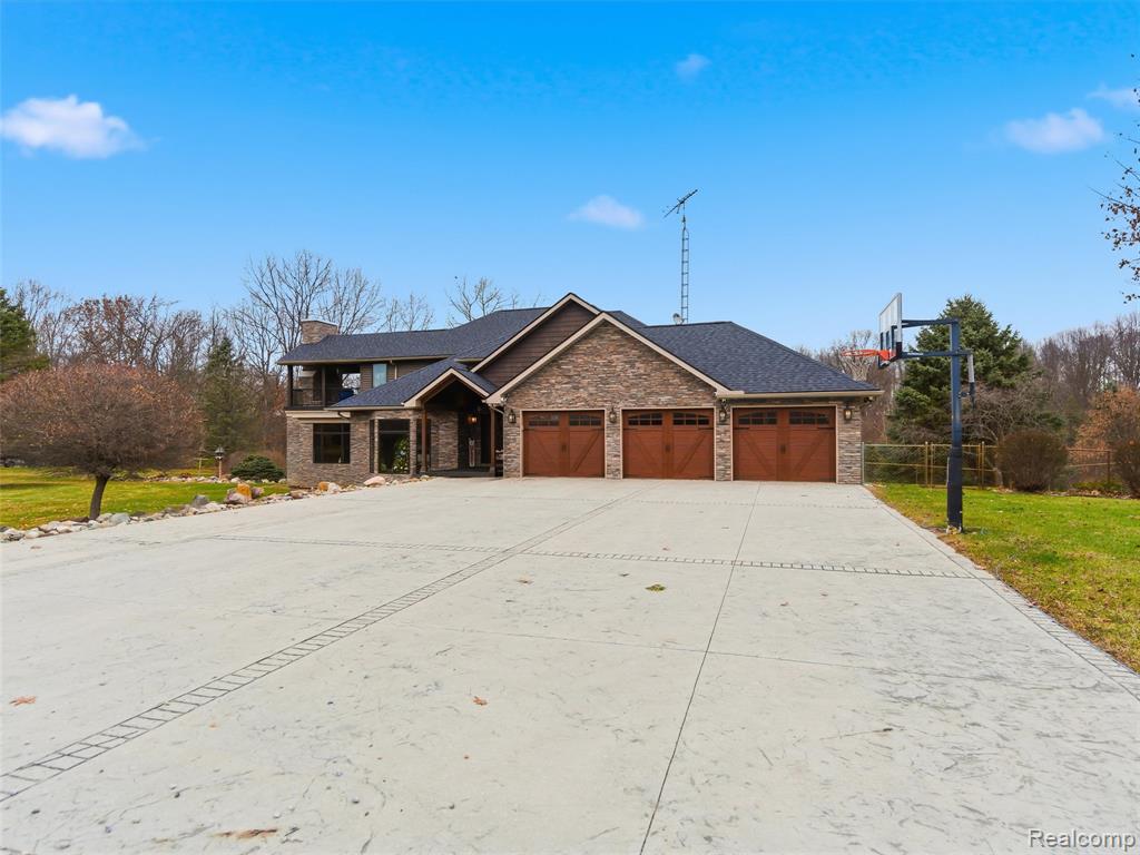 Exceptional architecture and craftsmanship define this luxury estate, featuring soaring ceilings, rich wood beams, knotty pine detailing, tongue-and-groove wood ceilings, hand-scraped hardwood flooring, and stunning custom stacked-stone accents throughout. Situated on 48 scenic acres, the property offers manicured landscaping, open fields, wooded areas, trails, and natural beauty in every direction. Enjoy three ponds with waterfalls, a heated fenced-in- inground pool, and an enclosed 4-season cabana for year-round enjoyment.Inside, the gourmet chef’s kitchen impresses with oversized island, a stone-arched chef’s range nook, Thermador appliances, double ovens, and a built-in Miele espresso system. Additional features include panoramic windows, Trex decking surrounding the home, an oversized laundry/mud room, geothermal heating system, and a secured built-in armory room.The spa-inspired primary suite offers a freestanding soaking tub, beautifully tiled walk-in shower with stone flooring, dual stone vessel sinks, custom vanity, and a private balcony overlooking the property and outdoor stone fireplace. The home also includes three floor-to-ceiling stone fireplaces, a 3 car garage with stamped-concrete surround, and a fully heated 30x10 chicken coop.The finished walkout basement features surround sound, a theater screen and projector, a full wet bar, and generous entertaining space. A massive 2,688 sq ft pole barn provides ample room for equipment, storage, or hobbies. The property is secluded, gated for full security, and located just 10 minutes from local shopping and amenities.