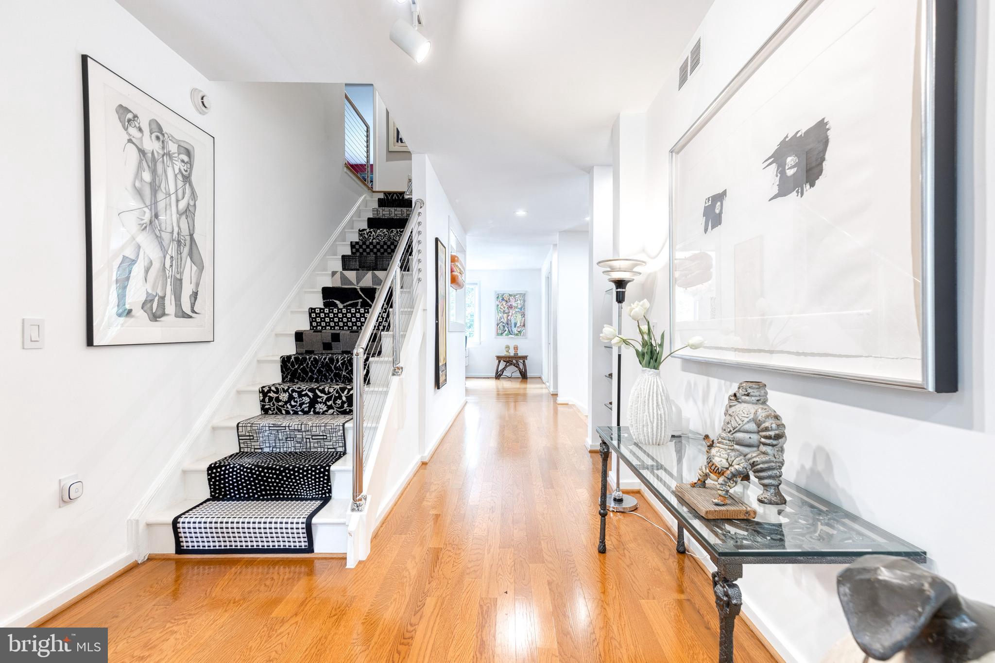 Discover the charm of 14 Roland Mews, an exceptional end-of-group townhouse in the sought-after Cross Keys community. Offering more than 3,900 square feet of beautifully designed living space, this oversized residence seamlessly blends timeless elegance with modern comfort, creating an ideal setting for both everyday living and effortless entertaining.A welcoming foyer opens to expansive, light-filled interiors highlighted by soaring ceilings, refined finishes, and a thoughtfully designed open floor plan. The spacious living, dining, and kitchen areas flow together beautifully, making gatherings both intimate and inviting. The gourmet kitchen, inspired by Frank Sinatra's Palm Springs home, showcases vintage St. Charles cabinetry, premium appliances, and generous counter space that will delight both home cooks and avid entertainers.The home features five generously sized bedrooms and five full bathrooms. The luxurious primary suite serves as a private retreat with a spa-inspired bath, dual vanities, and an oversized walk-in shower. Three additional bedrooms and two full bathrooms complete the second level, while the third floor offers a fifth bedroom—currently used as an art studio�����along with another full bath, providing flexible space for guests, work, or creative pursuits.Outdoor living is equally inviting, with three private patios that offer peaceful spaces to relax, entertain, or enjoy your morning coffee.Perfectly positioned in the heart of Cross Keys, 14 Roland Mews combines sophisticated living with exceptional convenience, just moments from premier shopping, dining, and neighborhood amenities. This remarkable home is truly one of a kind. Be sure to explore the accompanying photos to experience its distinctive character, thoughtful design, and timeless appeal.
