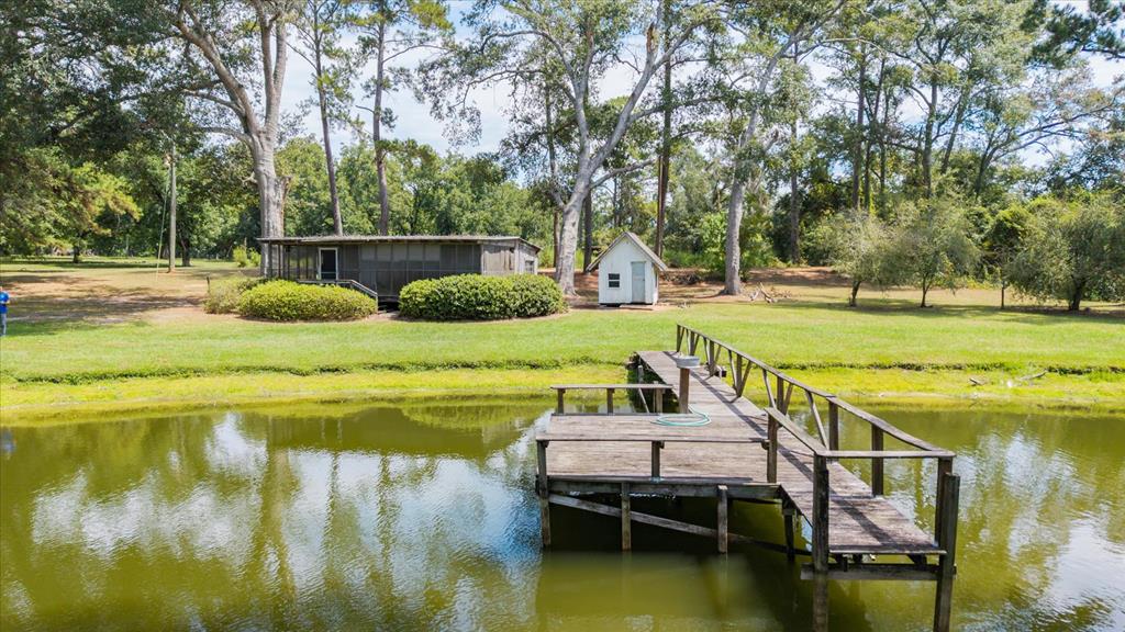 Just minutes from Historic Downtown Quitman, this 15-acre property offers the perfect blend of income potential and natural beauty. A grove of mature, irrigated, income-producing pecan trees stretches across the land, while a scenic cypress pond provides a peaceful backdrop filled with wildlife. Nestled within the property is a rustic 1-bedroom, 1-bath cabin with a large screened porch, perfect for weekend retreats or simple country living. Two wells, a workshop/shelter, and paved road frontage add to the convenience.  This versatile tract could also be potentially divided, making it an attractive option for multiple homesites or future investment. Whether you're seeking a private retreat, a small farm, or land with income and development potential, this South Georgia gem offers it all.