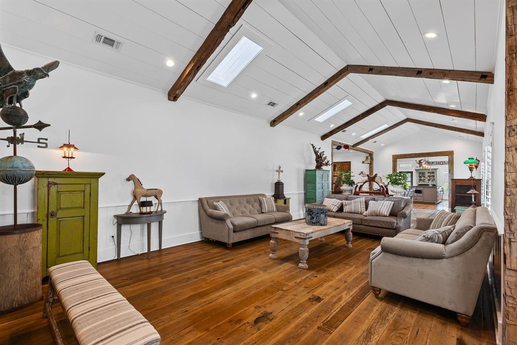 A collector's dream comes true with this farmhouse chic 2,756 square foot home, on 11-plus acres (being subdivided from a larger tract), with custom touches and tastefully hand-picked antique finishes! From the elegant 1860's Georgia wood floors and antique Chicago pavers, walk into this handsome home and be astounded by the thoughtful interior decorating that elevates the space. Barn beams from the 1840's give the vaulted ceilings a nice pop of warmth in the living room, kitchen, and dining areas. Skylights, white slat ceilings, and recessed lights also brighten up the great room. A generous kitchen includes a commercial gas range, warming tray with heat lamps, commercial vent, farm sink, dishwasher, separate ice maker by the pantry, and custom lights. The walk-in pantry comes with an antique door. The primary ensuite bedroom will impress with a spa-like bathroom that has a luxurious interior with a separate tiled shower, soaking tub, and separate double sinks. Guests will enjoy the spare bedroom with a modern hall bathroom with a tiled walk-in shower. A second living space will make the perfect family room or can be turned into a bedroom. Additional touches include custom-made Gothic window, Kohler faucets, plantation blinds from Custom Shutters, GE monogram appliances, restoration hardware vanities with solid surface Caesar Stone tops, handmade walnut doors, and handmade cupola. Sit on the oversized 1,009 square-foot deck and appreciate the mature trees that were planted in the fall of 2024. Parking is a breeze with a concrete drive and 600 square-foot garage. This house also comes with Prierfert Ponderosa fencing, spray foam in the attic and pier and beam areas, and large scenic pond. This spectacular place provides lots of curb appeal, including Copper Bevolo gas lanterns from New Orleans--all with acreage close to town. Don't let the 1940 year built fool you. The original home was re-built and 1500 feet added by a true craftsman, master carpenter!
