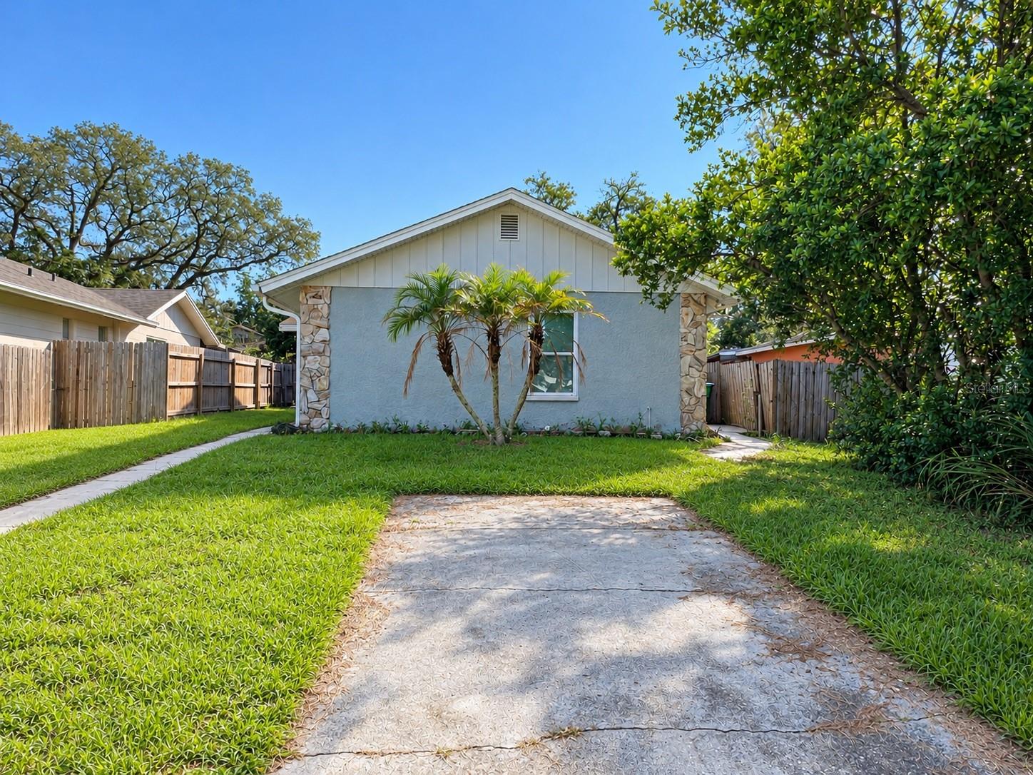 SPACE, FLEXIBILITY, AND INVESTMENT POTENTIAL! Whether you're searching for your next home or an addition to your rental portfolio, this 4-bedroom, 3-bathroom concrete block home in Tampa's Terrace Park neighborhood deserves a closer look! Offering 1,305 square feet of living area and a versatile floor plan, this home combines practical features with plenty of opportunity to make it your own. Inside, you'll find tile flooring throughout, neutral interior colors, and a welcoming living room highlighted by a distinctive floor-to-ceiling stone fireplace surround. The spacious kitchen features white cabinetry, generous counter space, a tile backsplash, and a large center island offering additional workspace and casual seating. Sliding glass doors bring natural light into the kitchen and dining area.Four bedrooms and three full bathrooms provide flexibility for a variety of living arrangements. The fourth bedroom features its own en-suite bathroom, offering additional privacy and versatility. Other features include ceiling fans, indoor laundry connections, and a screened porch for enjoying the Florida weather.Situated on a fenced lot with off-street parking and NO HOA fees, this property is conveniently located near the University of South Florida (USF), Busch Gardens, Adventure Island, AdventHealth Tampa, Moffitt Cancer Center, shopping, dining, and major roadways, including I-275. Its proximity to major educational, medical, and employment centers adds to its appeal for both homeowners and investors. Currently tenant-occupied, this property presents an opportunity for buyers interested in rental ownership or a future primary residence. The fireplace's operational condition is unknown and is not warranted by the seller. Schedule your private showing today!