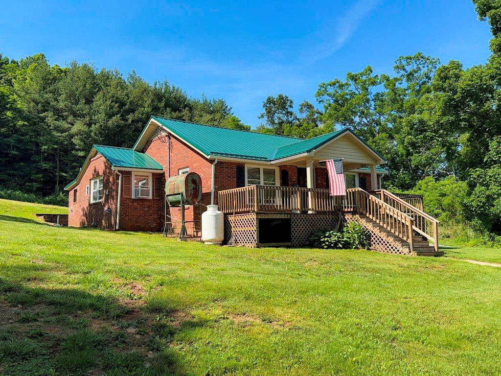 Private retreat on 18 acres complemented with a water feature in Elk Creek, VA. This move-in-ready cottage offers 3 bedrooms, 1.5 baths, and comfortable space inside and out. Updated with modern touches, the home features hardwood floors and generously sized rooms. Additional highlights include an equipment or livestock stall, a two-car carport, and a secure outbuilding for tools, equipment, and storage. The wooded property rises to a ridgetop and includes extensive road frontage, with four divided lots that offer future development potential. There is plenty of space for recreation, grazing, or hunting, along with easy access to the numerous outdoor amenities of Grayson County. Bring your horses to enjoy the area's many trail-riding opportunities or explore the potential for income-producing equestrian use. Schedule your showing soon to see this mountain getaway for yourself.