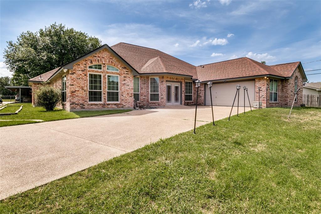 Welcome to your own private retreat in the heart of Benbrook, nestled on beautifully maintained, tree-filled acres.  This exceptional 2758 square ft. home offers 4 bedrooms and 3 full baths, including a flexible secondary bedroom with its own bath - ideal as a secondary primary suite, guest space, or multigenerational living. Filled with natural light from premium Andersen windows, the home features custom built-ins and inviting living areas. A cast-iron wood burning stove efficiently heats the entire home, adding warmth and character. Exceptional upgrades include an indoor central vacuum system, tankless water heater, Generac whole-home automatic generator, storm shelter, and a new roof in 2024.  Outdoor amenities are unmatched with a barn with electricity for a workshop, and a 4 space carport.  The property offers a park-like setting with mature trees, lush grass, and ample usable space for entertaining.  Conveniently located near shopping, dining, schools, and quick access to major highways.  This property delivers the perfect blend of peaceful country living with city convenience. The buyer is responsible for verifying measurements, all feeder schools, and taxes.