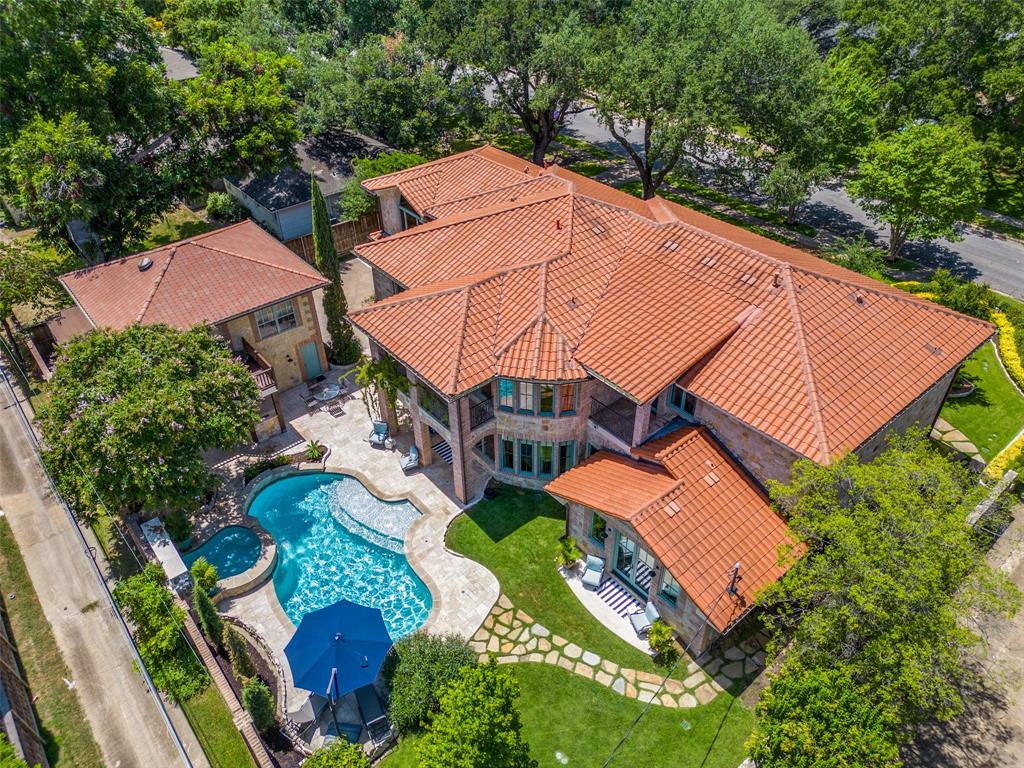 Welcome to a perfect combination of peace and elegance, steps from the amazing White Rock Lake, Dallas Arboretum and much more. This incredible home offers an open floor plan, 5 ensuite bedrooms (or 4 with office), pool, game room, media room, wine room, guest apartment - perfectly reconstructed and customized by the current owner with exceptional attention to detail.  The 7 by 11 entry features herringbone wood flooring.  The living is banked by a wall of windows featuring motorized shades overlooking the pool.  Both primary bedrooms overlook the back yard and feature built-ins, heated bathroom floors, incredible custom closets, separate tubs and showers and blackout custom window coverings.  Secondary bedrooms are generously sized with ensuite baths & WICs.  The family room, complete with wet bar, media area, balcony and game room, is able to accommodate a pool table and overlooks the pool.  The wine room opens to both front and back yards and is situated just below the play room with stage and fireplace.  Outside features a cooking area, pool, large yard and incredible gardens.  The guest quarters overlooks the beautiful yard and pool and offers a full apartment with 2 bedrooms, 1 bath, kitchen and living.