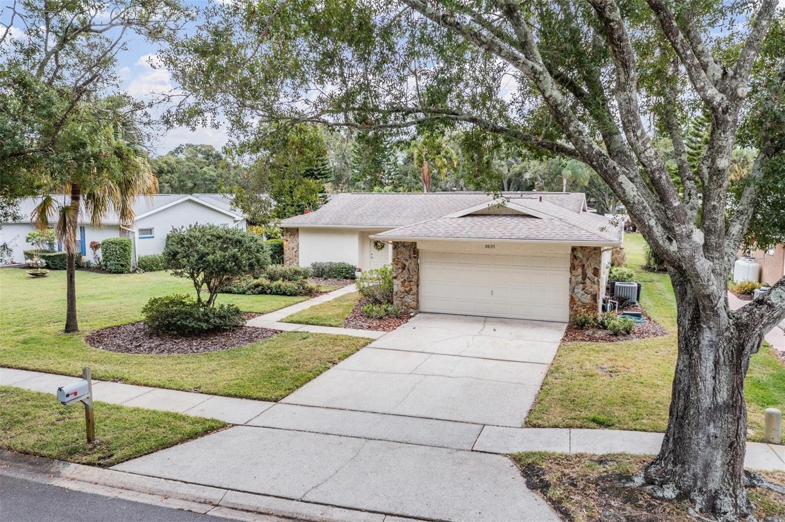 Beautifully updated and move-in ready, this 2-bedroom, 2-bath, 2-car garage home is nestled in Palm Harbor’s premier 55+ golf community, Highland Lakes. From the moment you arrive, you’ll appreciate the lush landscaping and welcoming curb appeal.
Step inside to a light and open floor plan featuring a spacious living and dining area that flows effortlessly into the fully updated kitchen. The kitchen showcases granite countertops, soft-close cabinetry, stainless steel appliances, and a breakfast bar, perfect for casual dining or entertaining. The adjoining dining nook offers a sunny spot to enjoy morning coffee.  Both bedrooms are generously sized, with the primary suite offering a beautifully updated en-suite bath complete with a sleek vanity, modern fixtures, and a glass-enclosed walk-in shower. The second bath has also been tastefully remodeled with neutral finishes and a quartz countertop. Additional highlights include wood-look tile flooring, a spacious walk-in closet, an indoor laundry room with extra shelving, and a screened lanai overlooking the peaceful backyard, ideal for relaxing with friends or enjoying Florida’s year-round sunshine.  Recent updates include impact windows (2023), roof (2019), Centricon termite system, and updated bathrooms for peace of mind and style.  Ideally located near award-winning Gulf beaches, top-rated restaurants and shopping, world-class healthcare, major sports venues, and two international airports, this home offers the perfect combination of comfort, convenience, and resort-style living.Highland Lakes provides numerous amenities, including three Executive 9-hole golf courses, a Clubhouse with a heated Olympic-size pool and spa, tennis courts, bocce, pickleball, shuffleboard, and fitness classes. Residents can engage in various clubs and social events, or unwind by the pool at the Lodge on Lake Tarpon, or explore the Pontoon Touring Boats. Schedule a viewing today to experience this beautiful home!