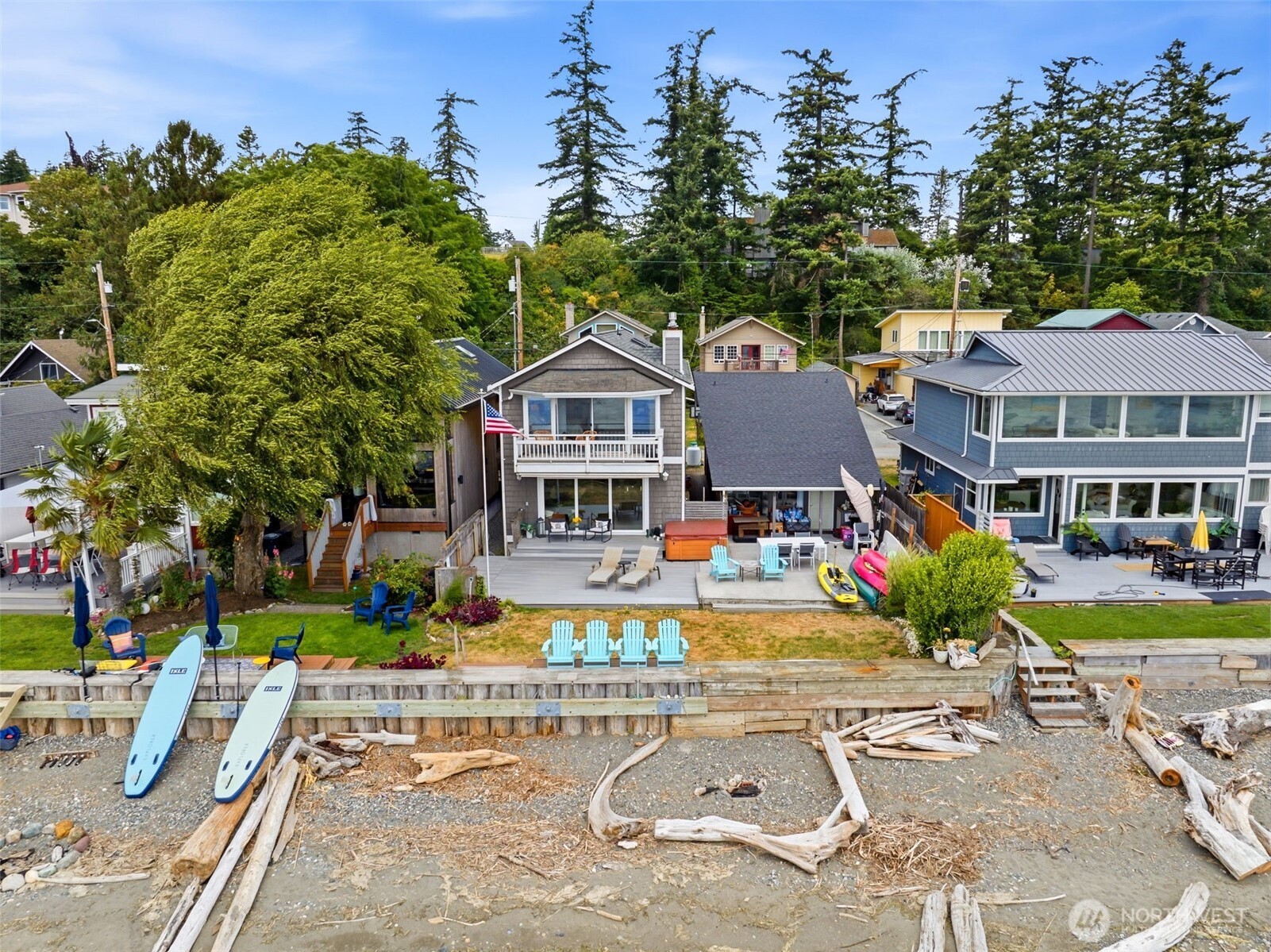 Rare opportunity to own two adjacent waterfront homes offered together in coveted Juniper Beach, where properties seldom become available. Enjoy the convenience of Camano Island's no-ferry lifestyle with easy bridge access while embracing nearly endless shoreline that stretches for what feels like miles at low tide. Whether you're seeking a multigenerational retreat, guest accommodations, investment potential, or the ultimate waterfront getaway, this unique offering delivers exceptional flexibility .Primary residence features 2,102 SF with 2 bedrooms plus flexible living spaces, 2 baths, oak hardwood floors, slab granite countertops, maple cabinetry, built-in dining cabinetry, a mid-century bar, two propane fireplaces, spacious waterfront decks, and a luxurious upper-level primary retreat with spa-inspired bath, fireplace, private view deck, and office/sitting area .Neighboring beach cottage offers 896 SF with vaulted cedar ceilings, loft, open-concept living, mini-split heating and A/C, stainless appliances, Trex deck, driftwood chandelier, and panoramic waterfront views—ideal for guests, extended living, or additional rental possibilities. Both homes share a beautifully bulkheaded shoreline with incredible opportunities for beachcombing, kayaking, paddleboarding, wildlife viewing, and unforgettable sunsets. A truly rare chance to own a one-of-a-kind waterfront compound in one of Camano Island's most desirable beachfront communities. Residences available individually.