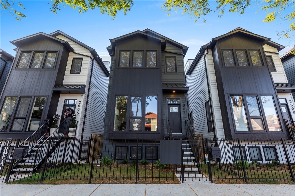 Introducing the Carmen Collection - Phase II. Nestled in a community of 19 brand new single-family homes in the picturesque and highly sought-after Lincoln Square neighborhood, 2607 Carmen is meticulously crafted in a modern farmhouse style, exuding a distinct character and seamlessly blending luxury, comfort, and convenience. Large windows and lofty ceilings flood the home with natural light, and are complemented by gleaming white oak hardwood floors that leave a lasting impression.     Upon entering, the main level welcomes you with a spacious entry closet, formal living and dining areas, and a centerpiece built-in pantry. The family room showcases a cozy gas fireplace with quartz surround and open shelving which flows into a well-placed patio, perfect for grilling and entertaining.     The kitchen is equipped with top-of-the-line Bosch appliances, upgraded lighting, an expansive island featuring stylish quartz counters, and bar seating for five. Abundant storage is provided by way of large custom cabinets and multiple walk-in pantries/closets.    Ascending up a level reveals three generously sized bedrooms with large walk-in closets, two full bathrooms each with double vanities, a convenient linen closet, and a full-sized laundry room complete with a built-in sink and room for additional storage. The primary bath offers luxurious features like heated tile floors, an oversized walk-in rain shower, a deep soaking tub, built-in vanity/make-up table, and a separate toilet closet.  Up another level and you reach the rooftop deck where you find an expansive and fully built out rooftop with Trex decking, another perfect outdoor space for entertaining, gardening, sunbathing, and more.    The lower level of the home offers two additional spacious bedrooms, an entertainment/theater/play area which boasts an impressive wet bar and beverage center, a full bathroom, and two sizable storage nooks. Equally delightful is the beautifully landscaped front yard and private rear patio with built-in garden bed, offering more outdoor space for relaxation or entertaining. Completing the home is a two-car garage with ample room for parking and storage.  Situated just a short stroll or bike ride away from multiple parks, this location offers abundant opportunities to immerse oneself in neighborhood activities as well as enjoy nature by way of nearby river trails for walking, jogging and biking. While offering a serene ambiance and tree-lined streets, the neighborhood is a short stroll from "The Square" with bustling cafes, restaurants, shops, and multiple transportation options, making 2607 Carmen and The Carmen Collection a perfect place to call home.  This is the last of 19 homes and we've saved the best for last - don't miss your chance to be a part of this amazing community!