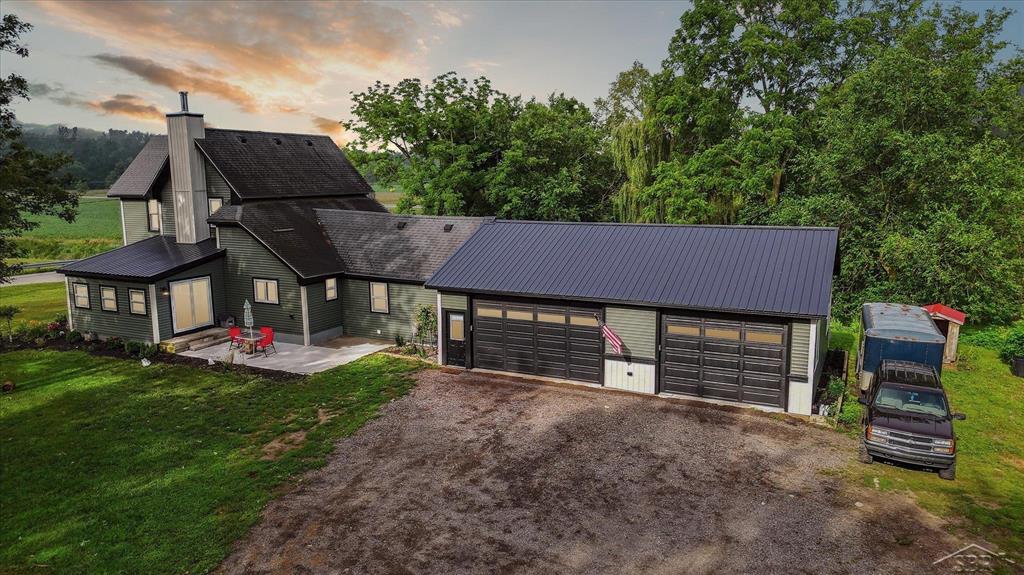 A timeless treasure on Tittabawassee! Originally built in 1939, this stunner has been completely reimagined from the studs up-think of it as the ultimate glow-up. NEW roof, windows, doors, siding, on demand water heater, furnace & AC! Every detail has been thoughtfully redone: electrical, plumbing, kitchen, bath-you name it! It's essentially a brand-new build-without the brand-new price tag. Step inside to discover soaring ceilings, beautifully refinished original hardwood floors, and a show-stopping main floor primary suite with heated floors, dual sinks, a walk-in tiled shower, and even a built in Bluetooth speaker fan so your morning playlist can sing right along with you. The kitchen is straight out of a farmhouse fairytale-complete with a deep apron sink, center island, granite countertops, and all the warmth and character you'd expect from a space that begs for Sunday morning pancakes and late-night conversations. Need a quiet place to work or create? One of the bedrooms doubles as a perfect home office with its own en suite half bath. You'll also love the spacious mudroom and main floor laundry that keep everyday living easy and organized. Upstairs, you'll find two generously sized bedrooms and a full bath-perfect for family, guests, or a little extra breathing room. Outside, the story gets even better-10 perfect square acres of pure Michigan beauty, complete with a peaceful creek, mature trees, a 3.5 car garage thats heated and mostly insulated, and a massive barn ready for hobbies, horses, or your next big idea. Tucked in a prime, central Freeland location, Midland School Districts, this home is the perfect mix of countryside calm and everyday convenience. All that's missing is you!