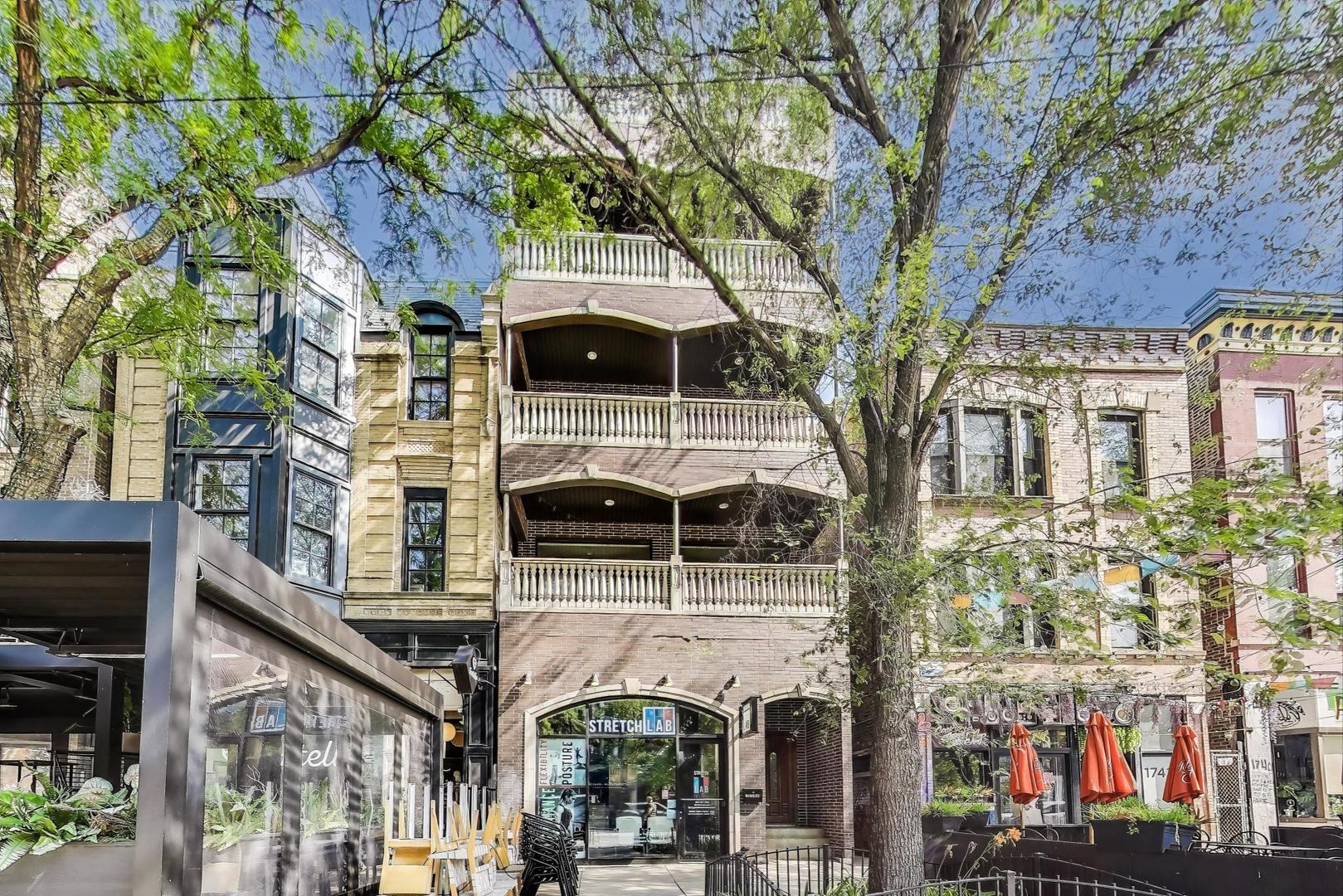 Welcome to this expansive 3-bedroom, 2.5-bathroom duplex-up nestled in the heart of Wicker Park. Set on a vibrant stretch of Division Street, this stylish home spans two sun-drenched levels and offers over 2,400 sq ft of interior space plus multiple private outdoor retreats.    The main level boasts a spacious, open-concept living and dining area anchored by a gas fireplace and flanked by oversized windows. A chef's kitchen features custom cabinetry, granite countertops, stainless steel appliances, and a large island with breakfast bar, perfect for entertaining. Step outside to a charming, covered balcony with lush turf and decorative balustrades.    Upstairs, the primary suite impresses with a large walk-in closet, spa-like bathroom with dual vanity and oversized walk-in shower, and direct access to a second private balcony. Two additional bedrooms offer ample space for guests, office, or nursery. A full-size laundry closet adds convenience.    One of the standout features is the private rooftop deck with sweeping skyline views, ideal for summer gatherings or quiet evenings above the city.    Other highlights include hardwood floors throughout, high ceilings, central HVAC, and gated exterior entry. Walkable to restaurants, shopping, nightlife, and the Blue Line. Garage parking is included in the price.