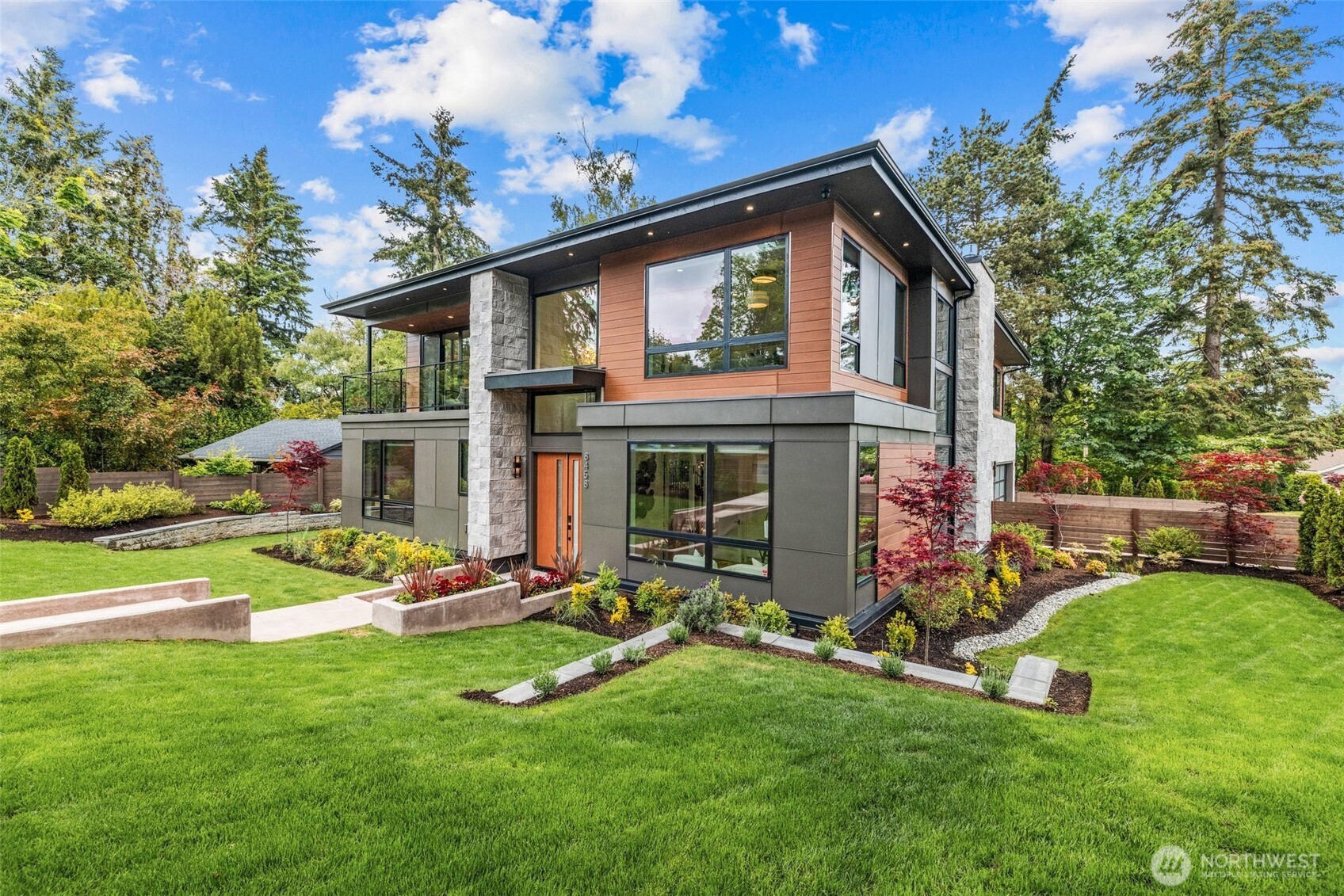 Refined modern luxury in the heart of Medina Heights. This contemporary home offers exceptional design, privacy, and livability on a quiet, walkable street with views of DT Bellevue. Sun-filled interiors feature soaring ceilings, expansive windows, and high-end finishes throughout. The open-concept main level is ideal for entertaining, highlighted by a chef’s kitchen, private office, and en-suite guest suite. Upstairs, the serene primary retreat includes a spa-inspired bath and private deck, along with additional en-suite bedrooms and a loft. The lower level provides flexible living with theater, wine room, and bonus space. Better than new, thoughtfully designed, and ideally located minutes from old Bellevue and top-rated schools.